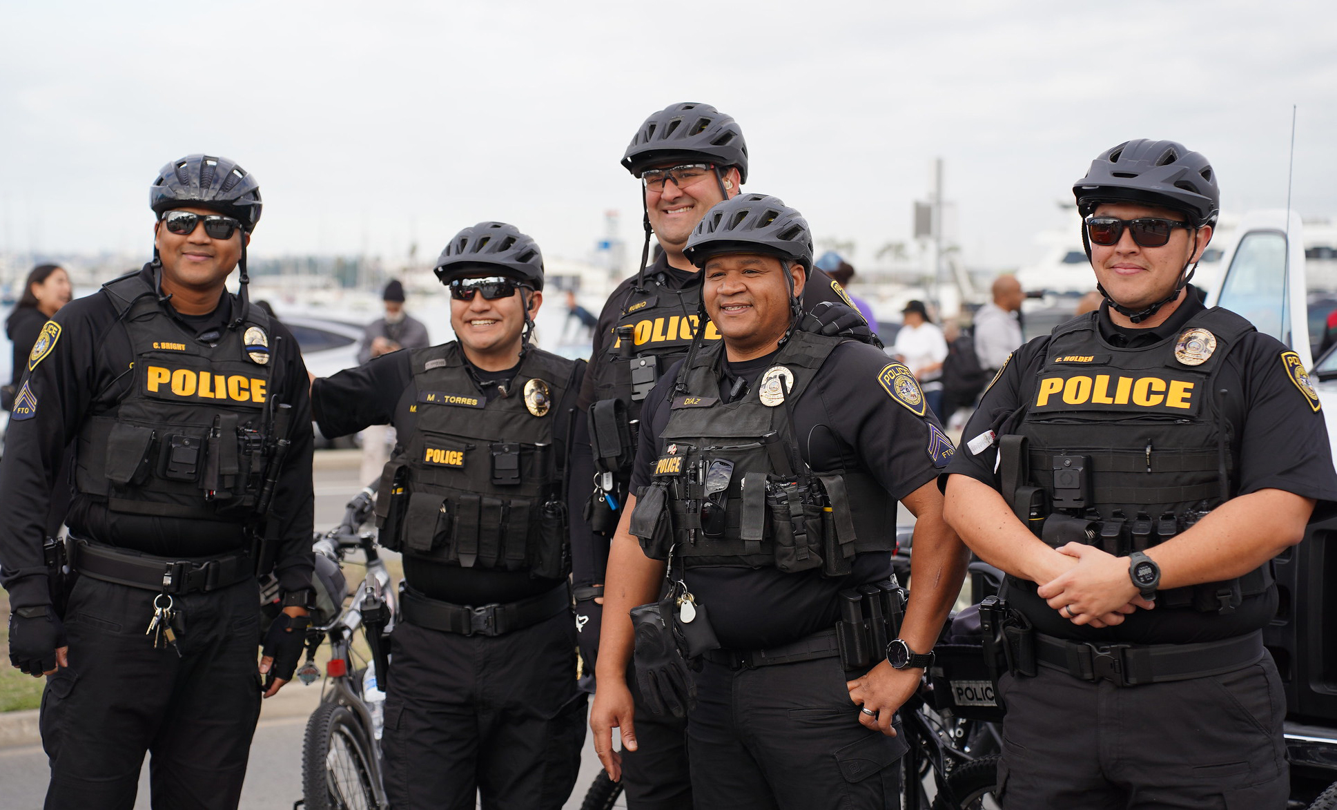 Five college police in uniforms and bike helmets at the MLK parade