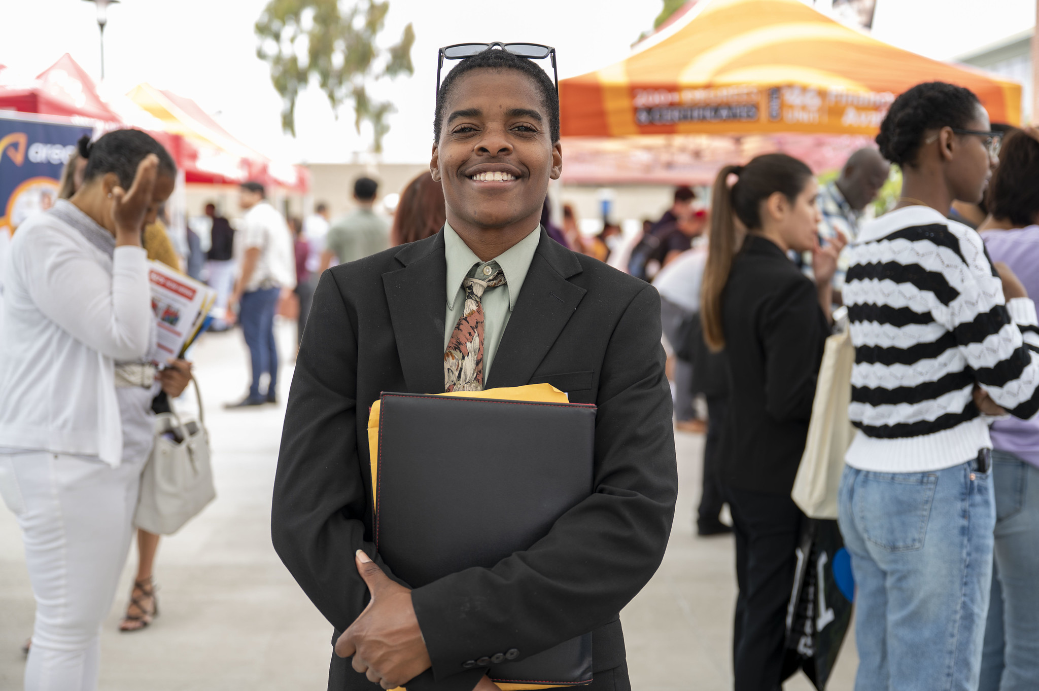 A student in a black suit at a career fair