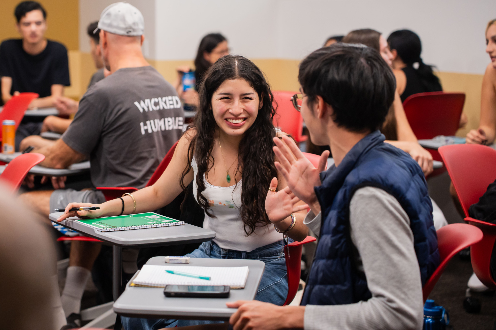 Two students talking in a classroom