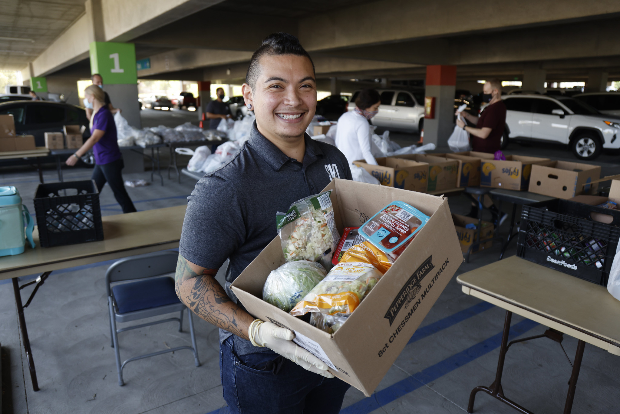 A student holds a box of food to be distributed