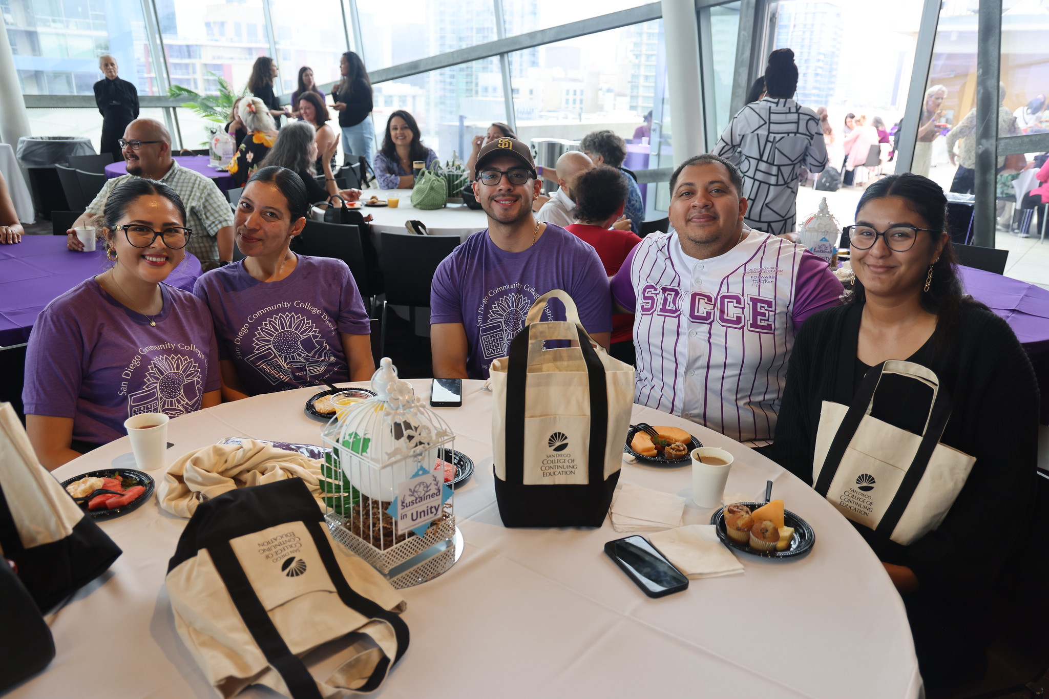 Five employees sit at a table during College of Continuing Education's convocation