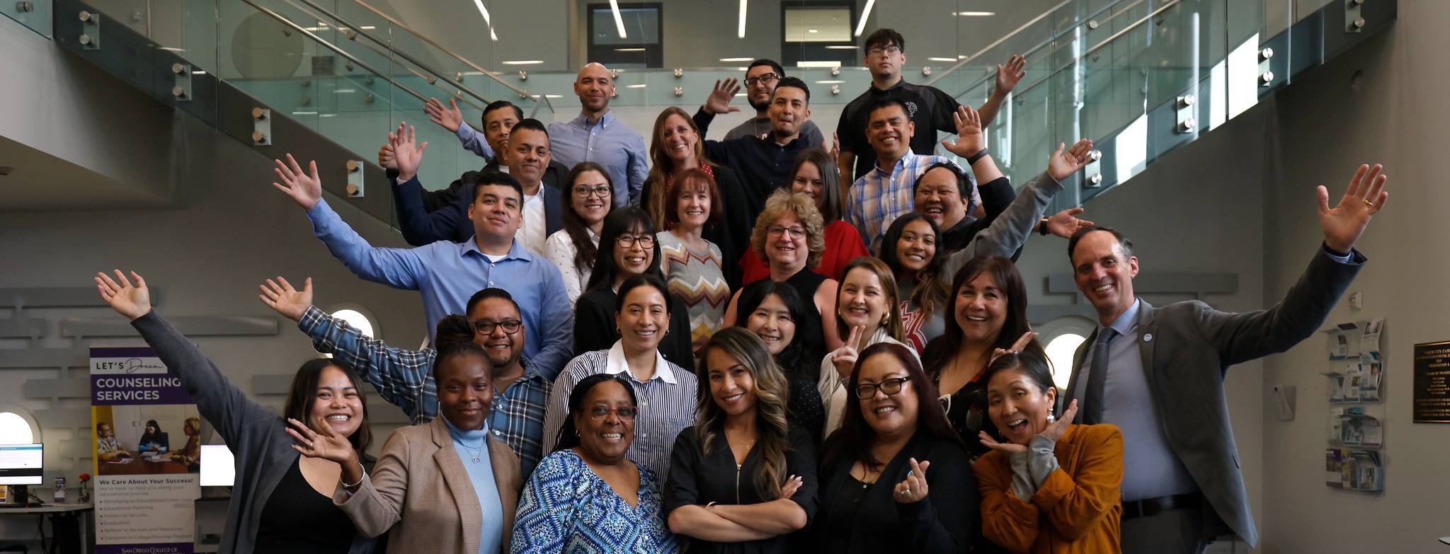 The chancellor and 28 employees from the Classified Leadership Development Academy on a set of stairs.