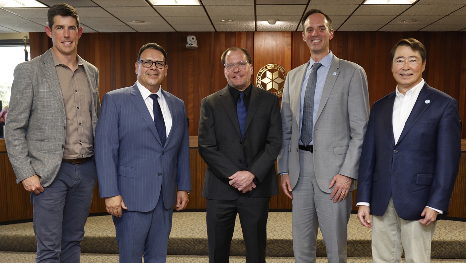 The chancellor and vice chancellor of operations with three representatives from the firms