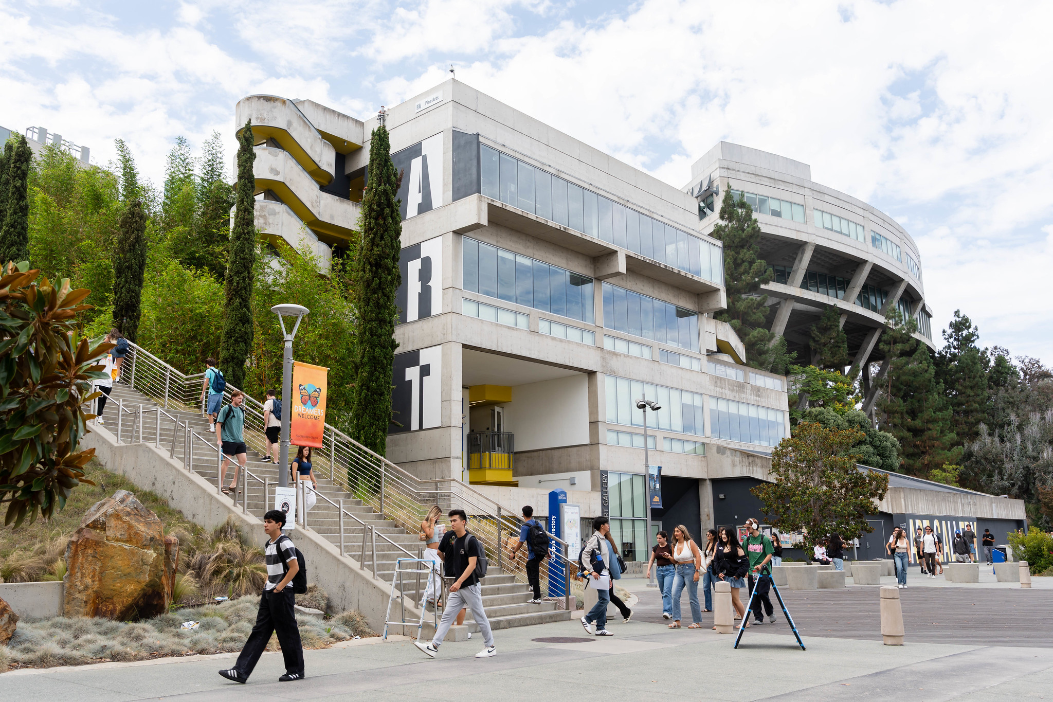Students walking on Mesa College campus in front of the art gallery building