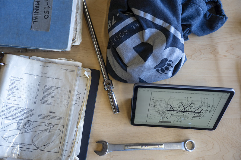 A table with tools and aviation schematics