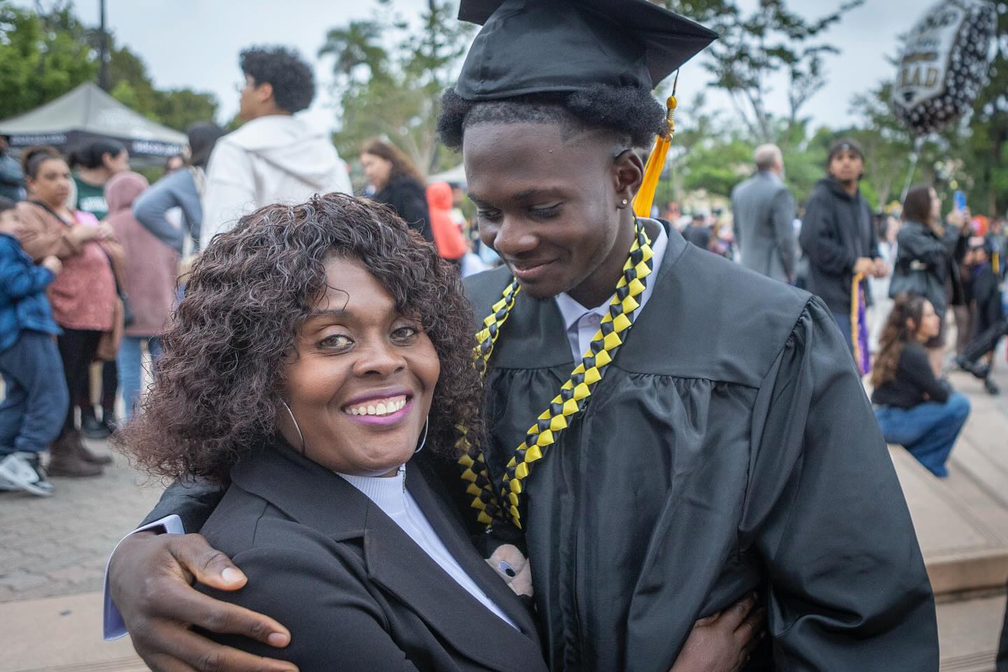 
A graduate hugs his mom at commencement.
