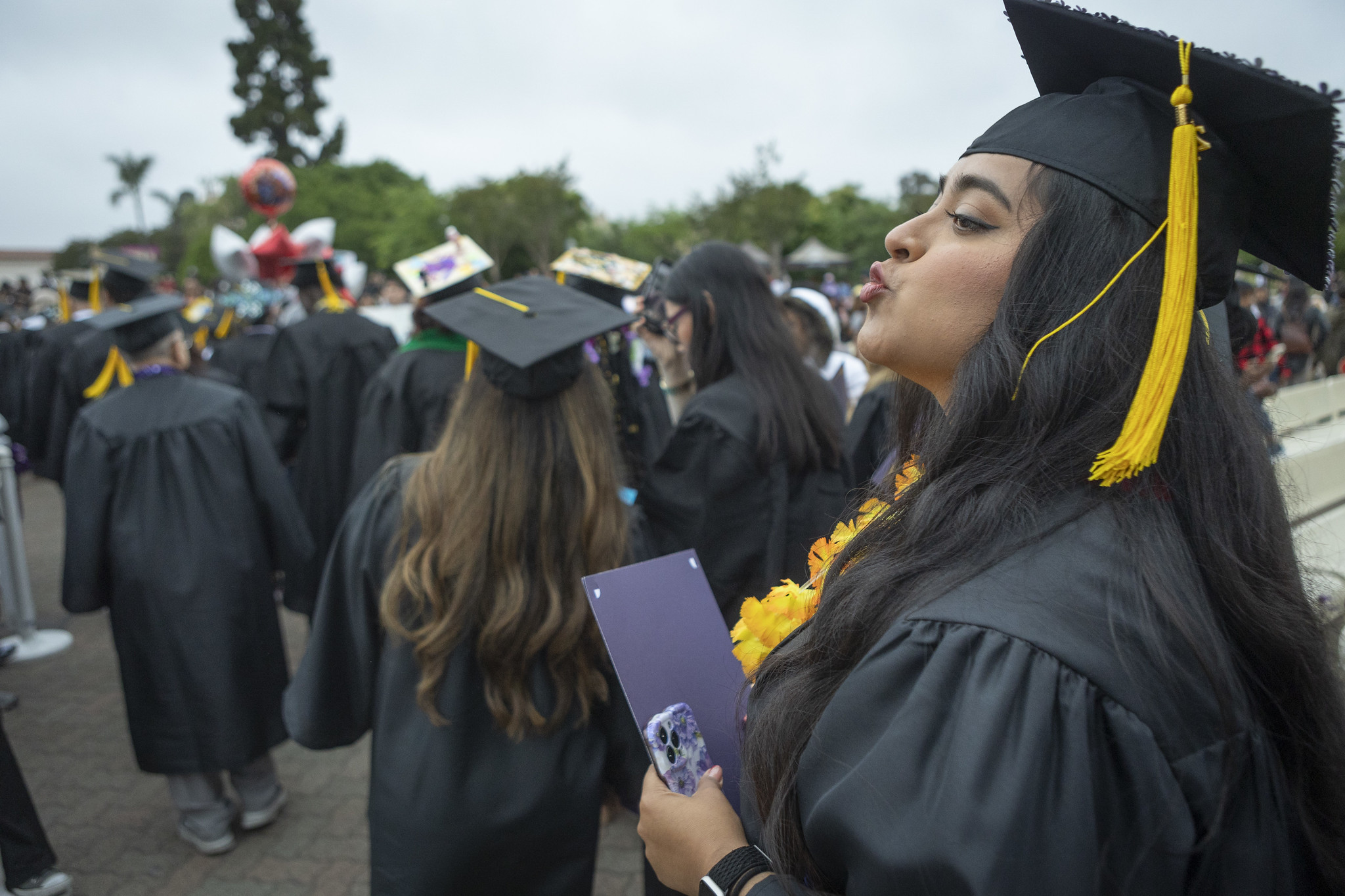
A graduate blows a kiss to the crowd.
