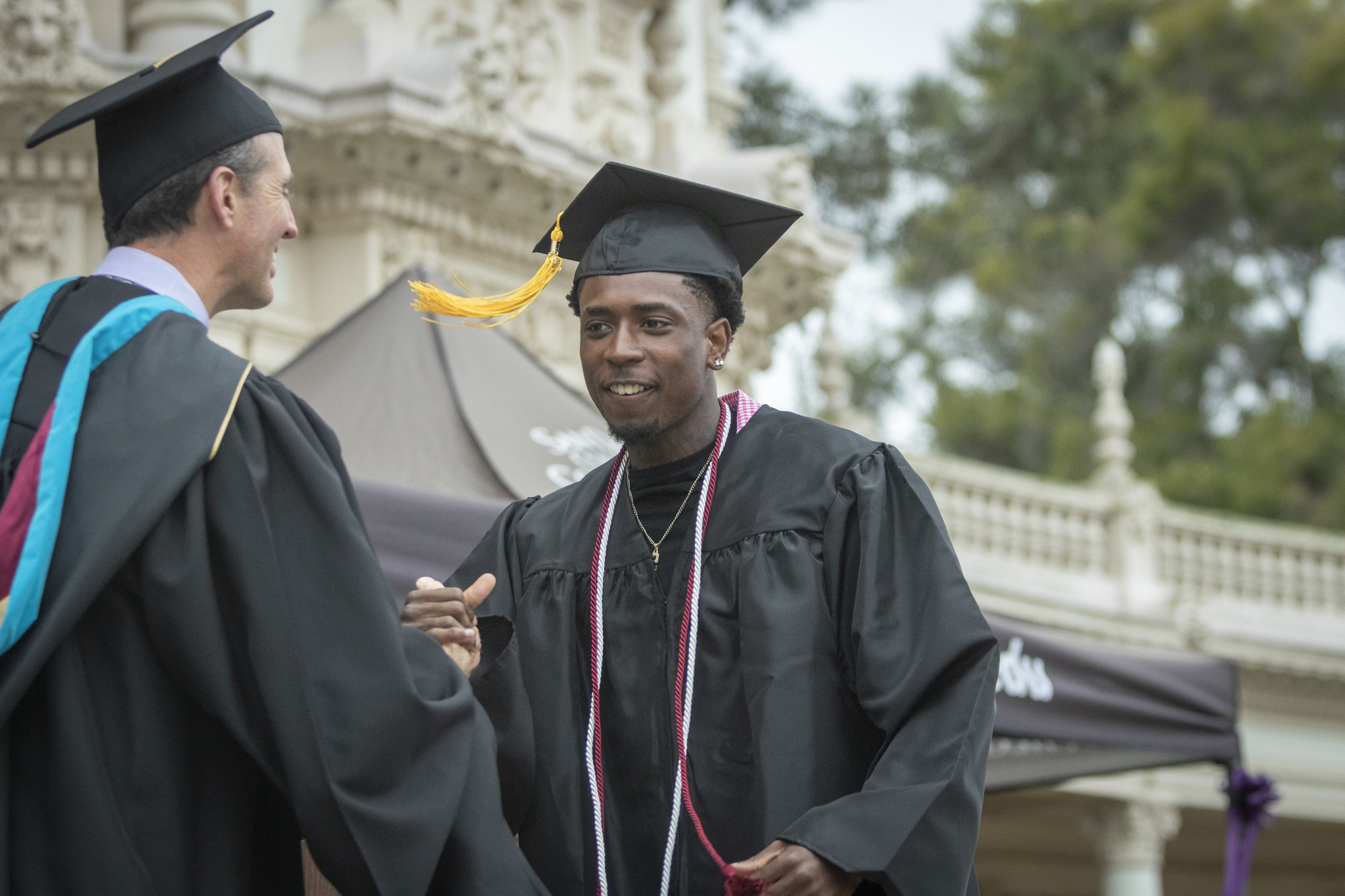 
A graduate shakes Chancellor Gregory Smith's hand as he receives his certificate.

