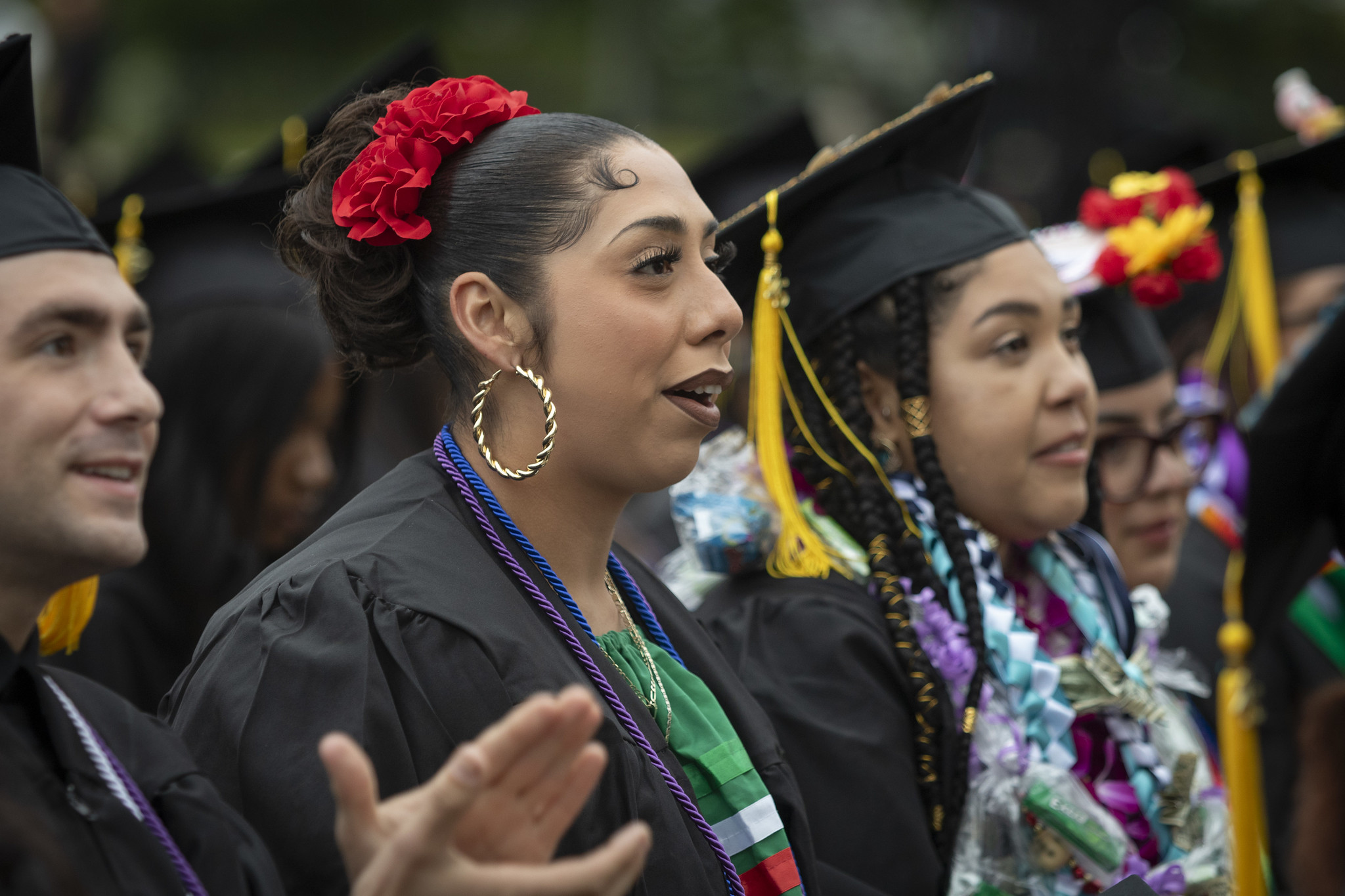 
Three graduates in the crowd.
