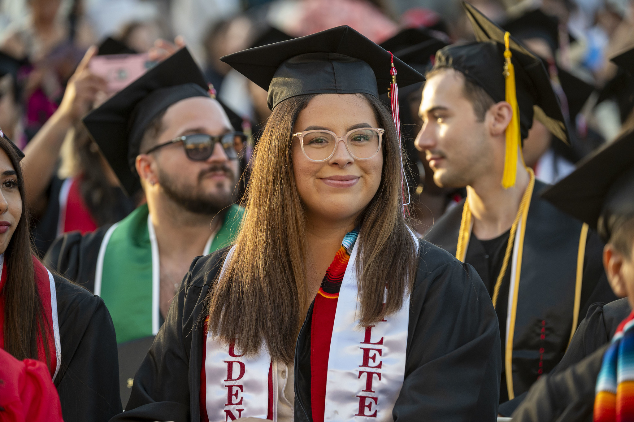 
A student athlete smiling in the audience.
