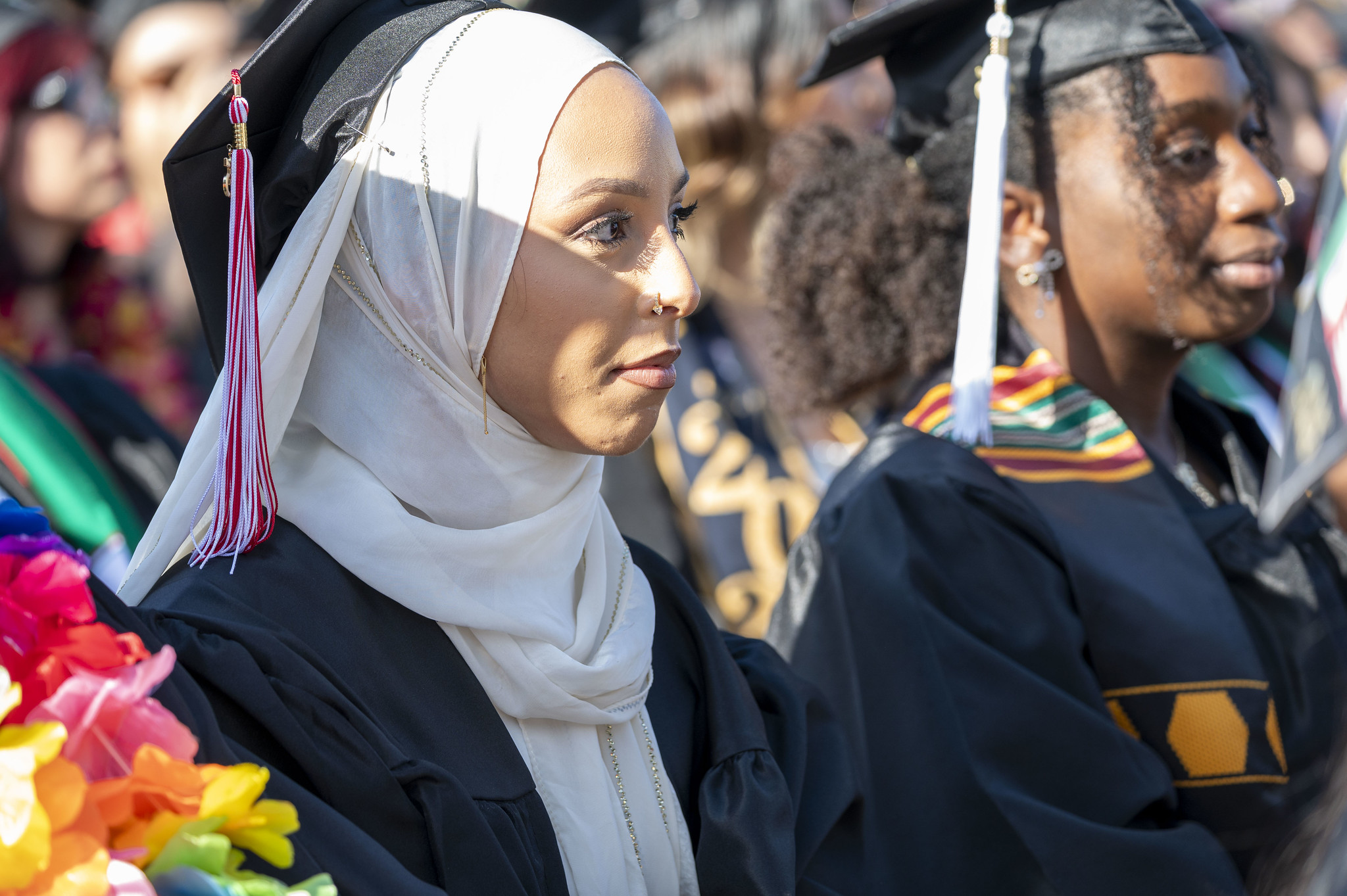 
A graduate seated at commencement.
