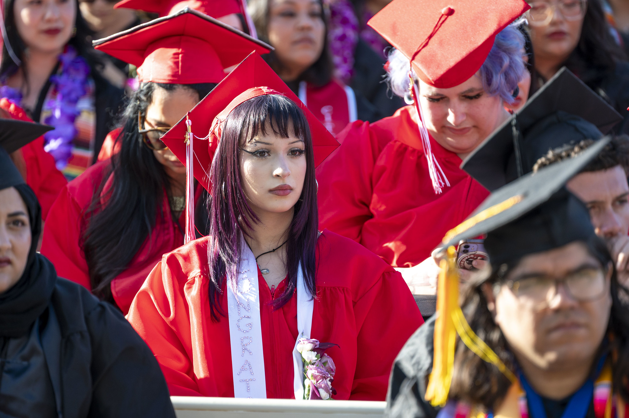
A graduate seated at commencement.
