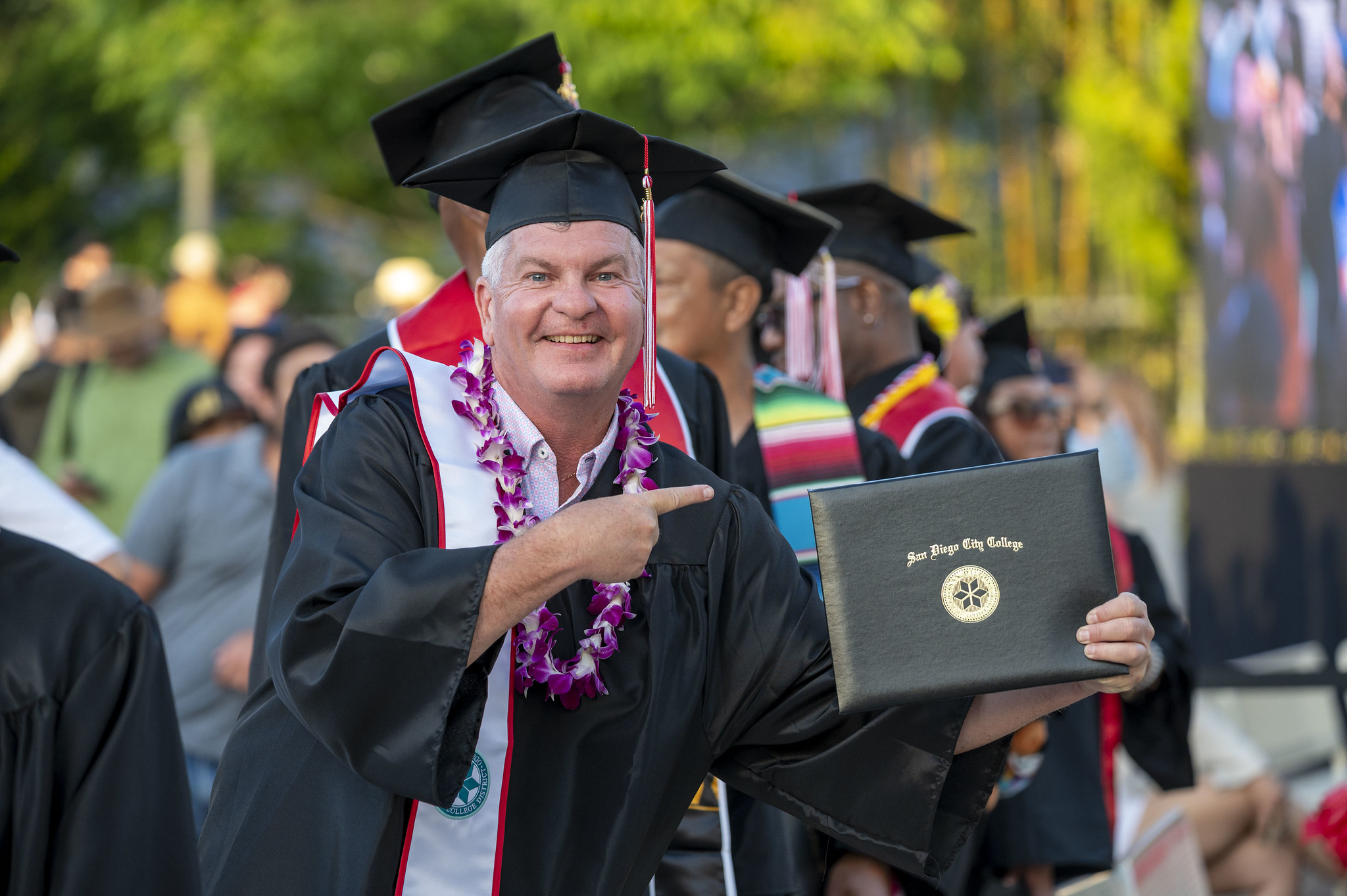
A graduate points to his degree.
