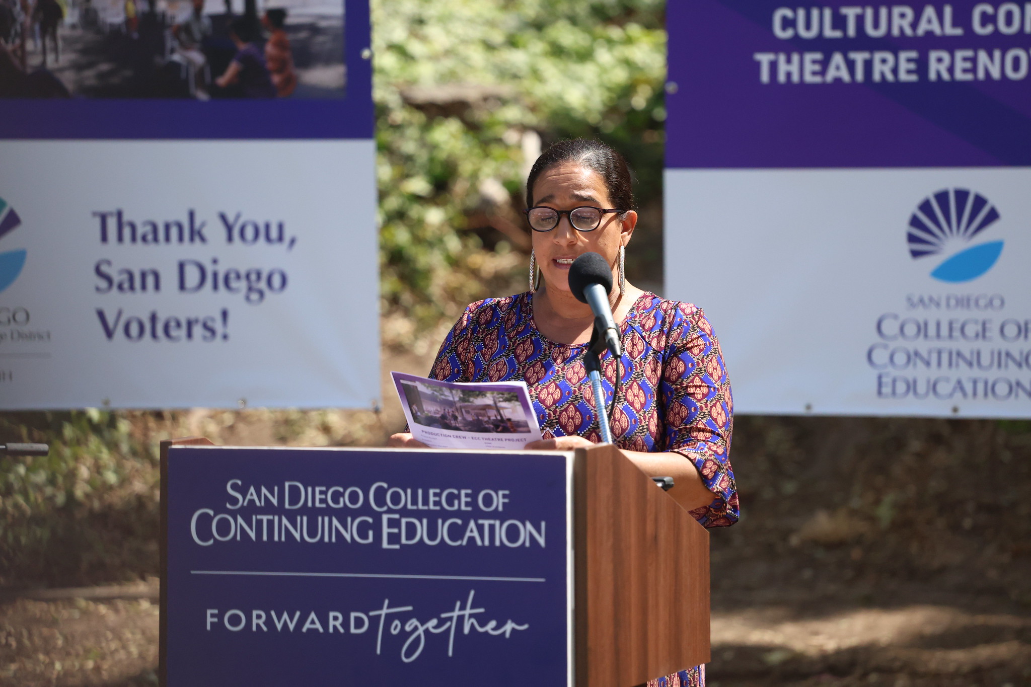 
A woman speaking at the podium.
