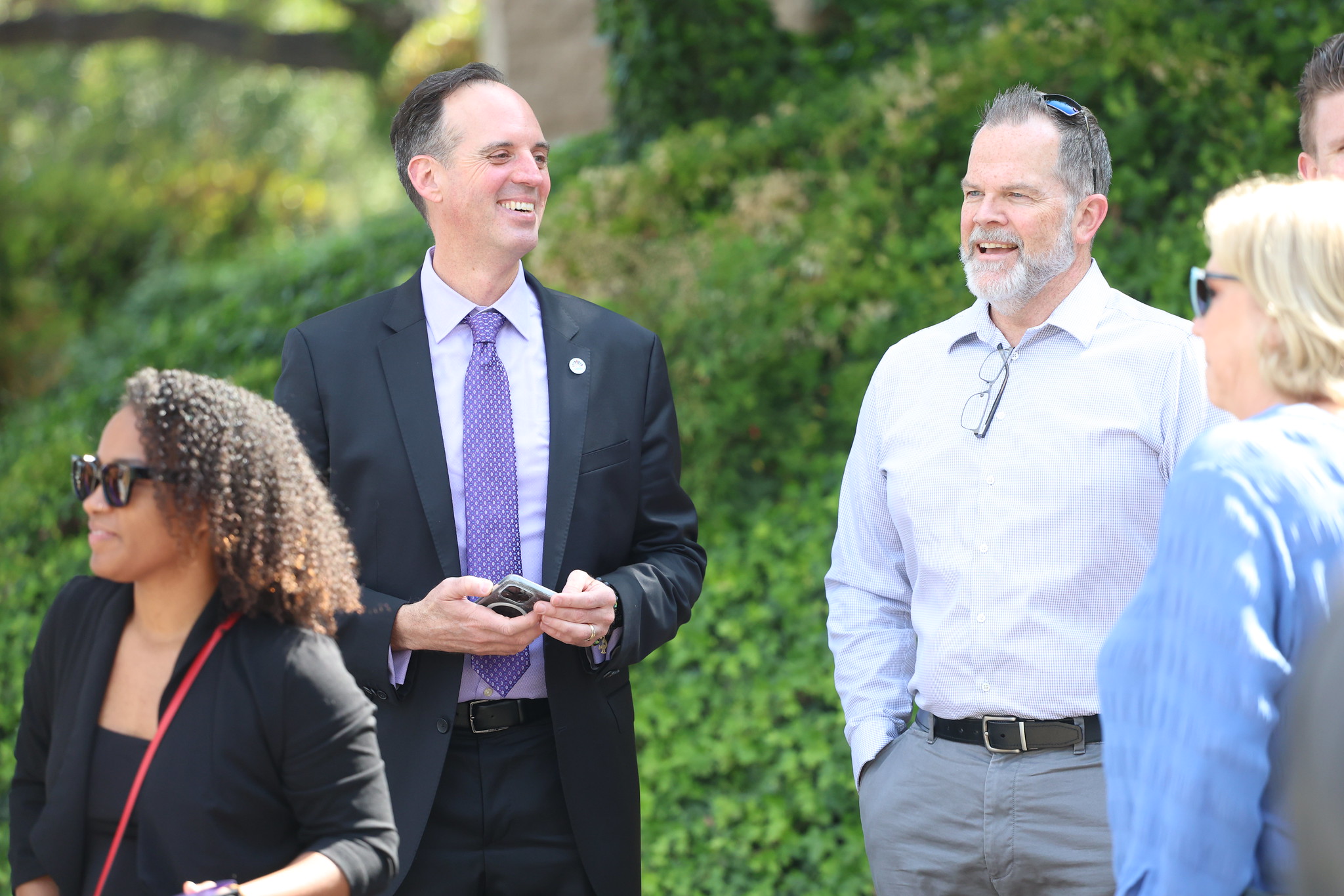 
Attendees, including Chancellor Smith, chatting at the event.
