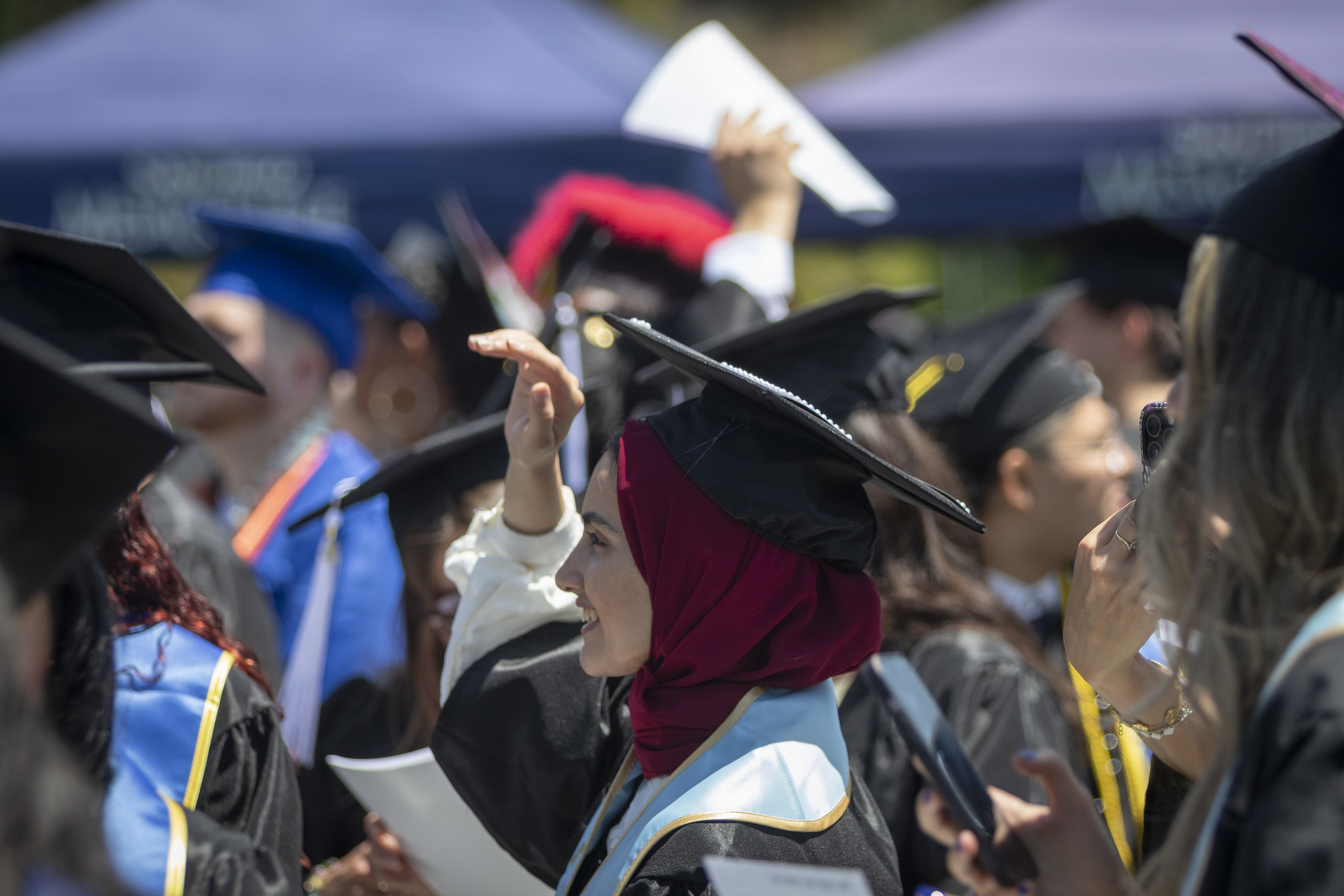 
A graduate in the audience at commencement.
