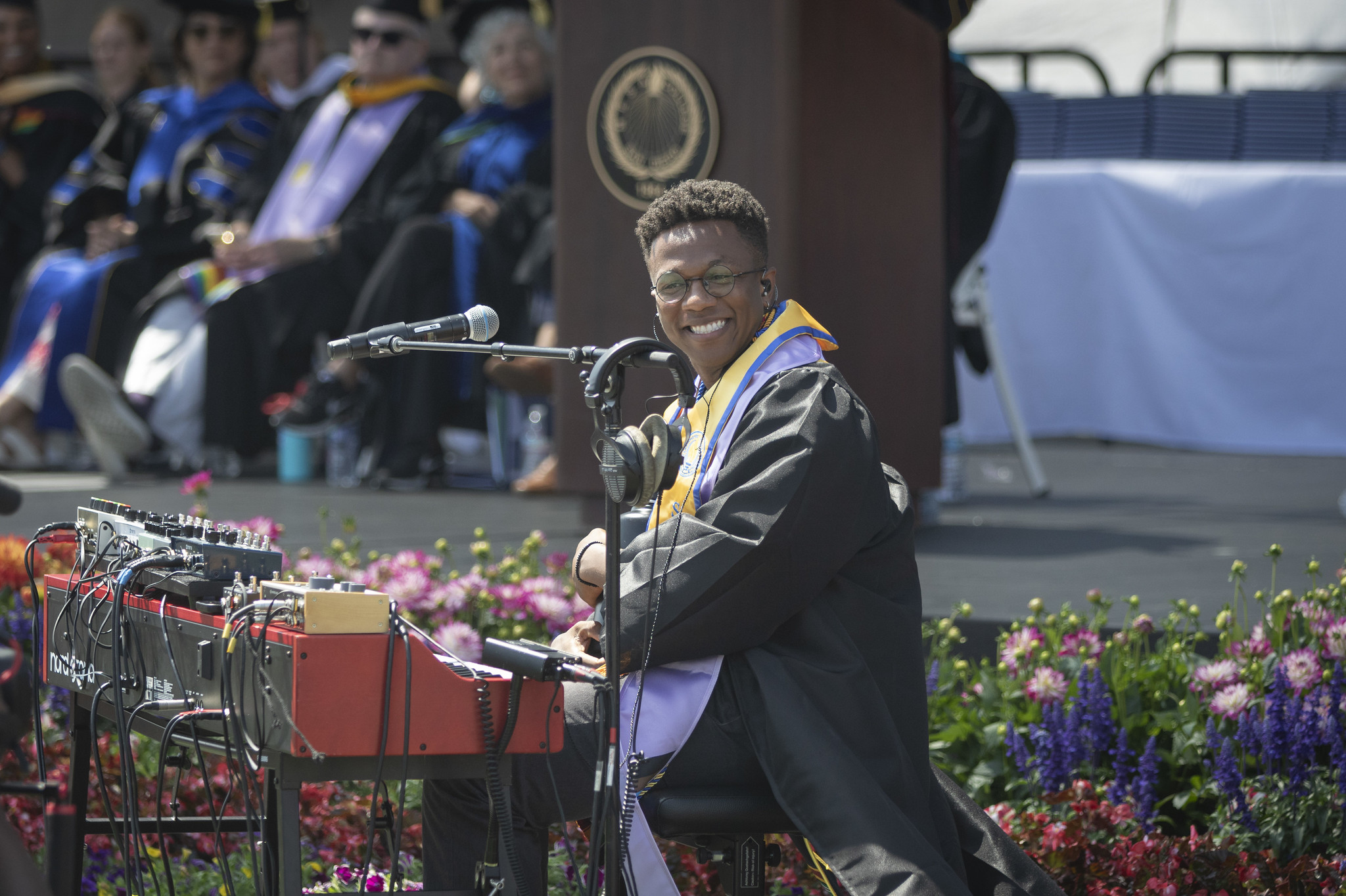 
Angel Wilson sitting a keyboard sings during the commencement ceremony.
