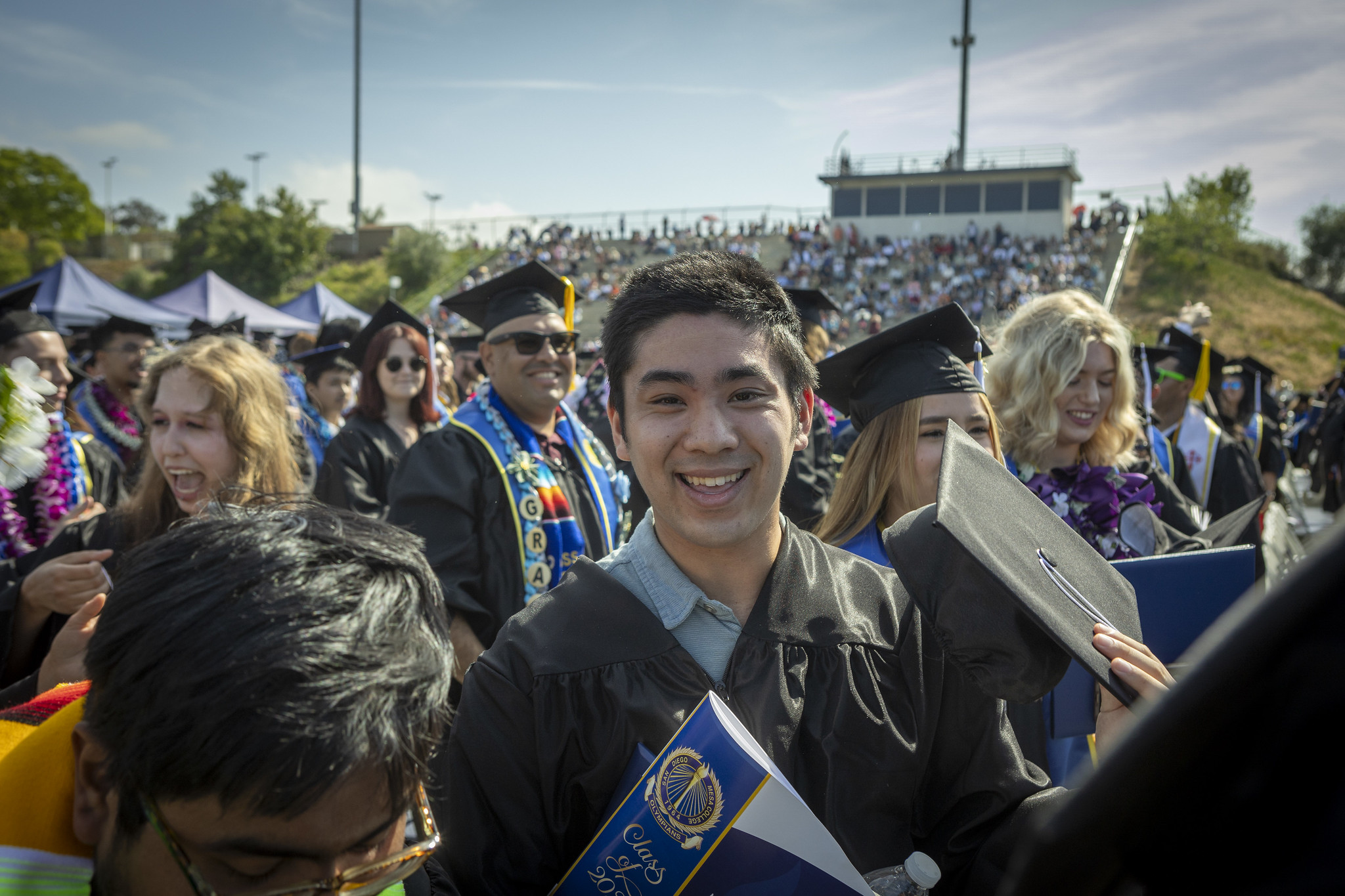 
A graduate in the crowd at commencement.
