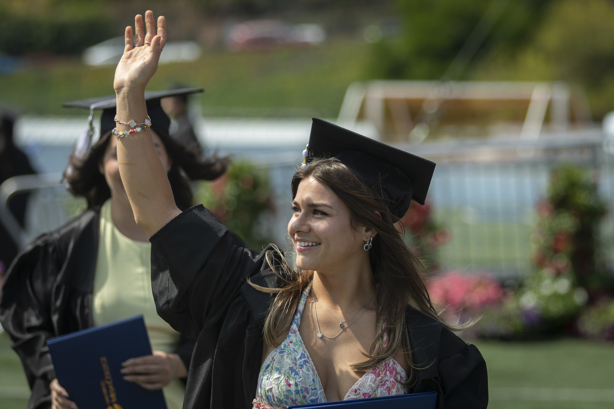 
A graduate waves to the crowd.
