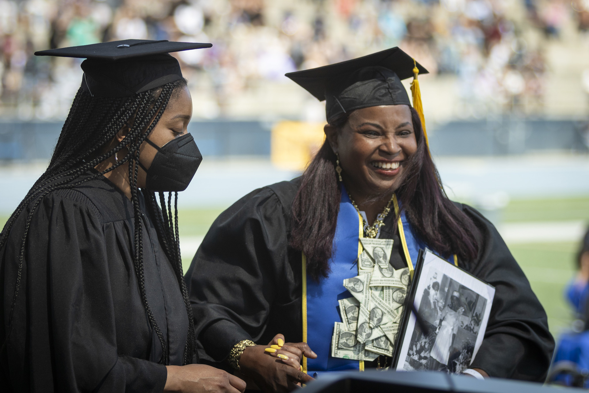 
A graduate smiling with her degree.
