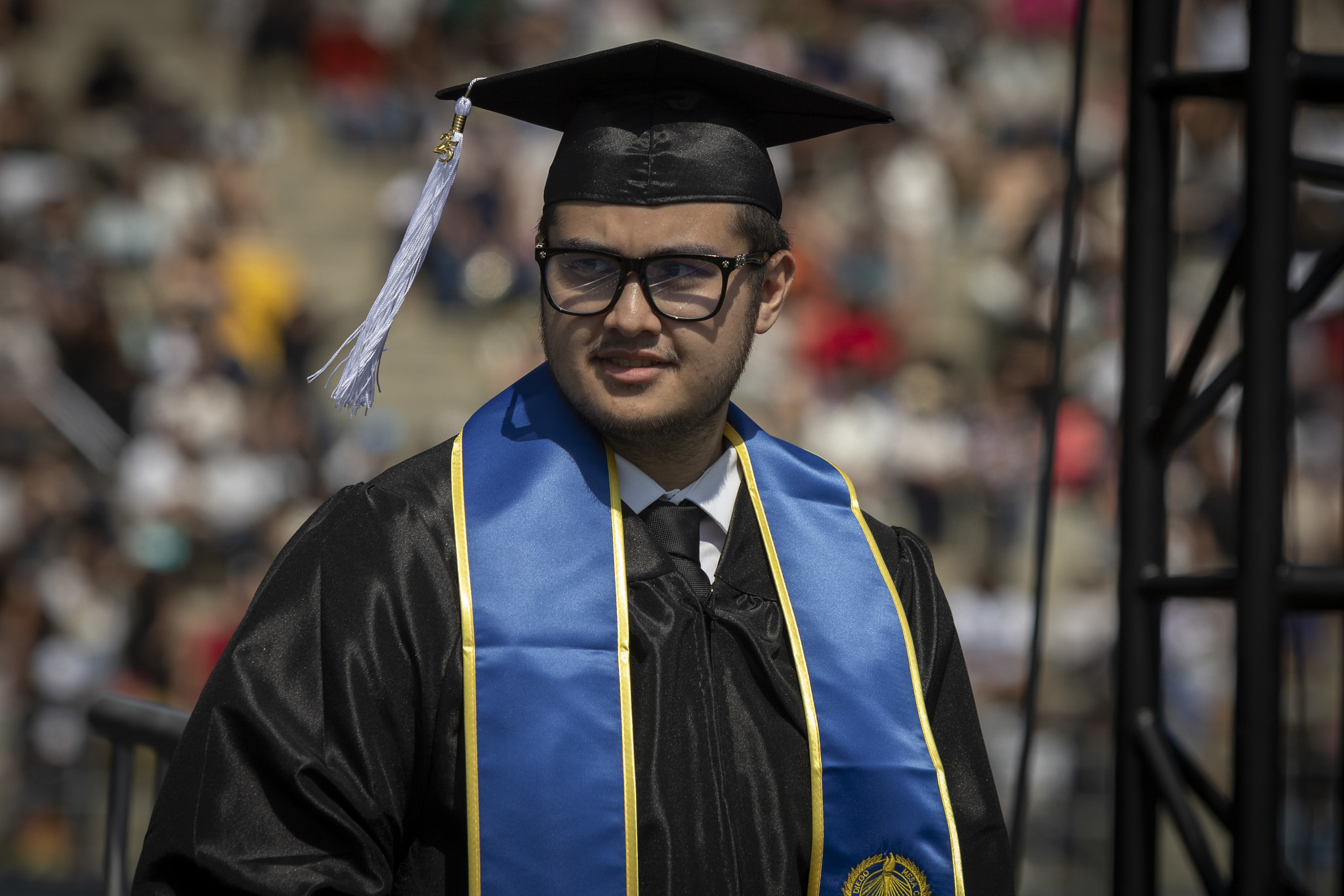 
A graduate walking at commencement.
