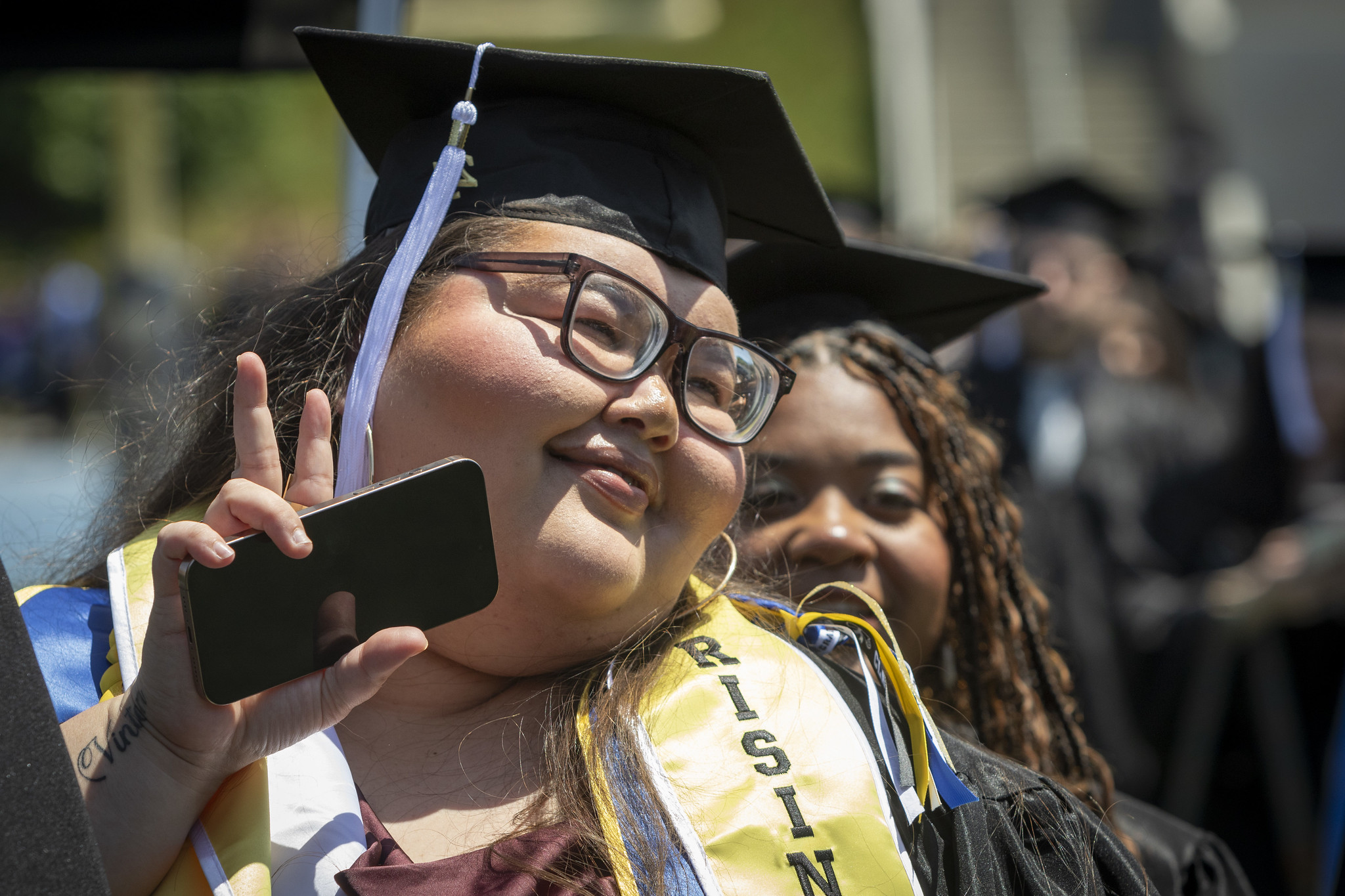 
A graduate gives a peace sign.
