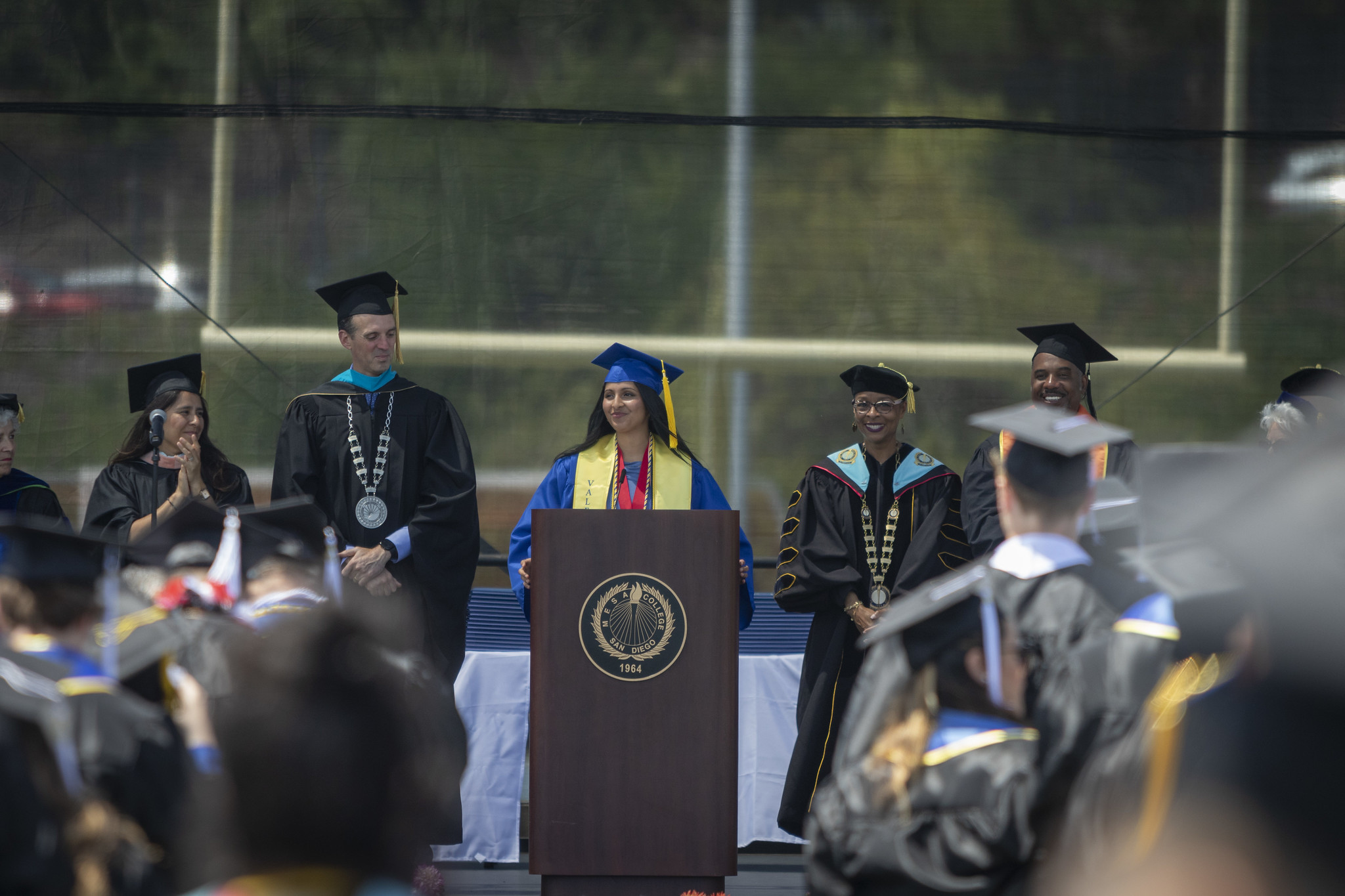 
A valedictorian speaking at the podium during commencement.
