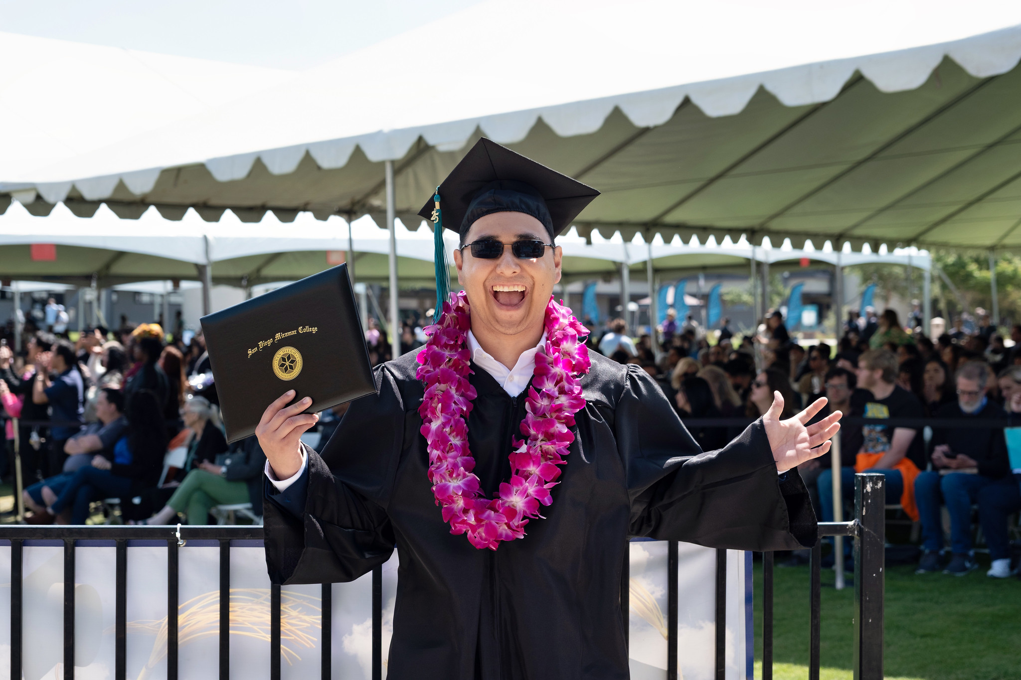 
A graduate is holding up his degree.
