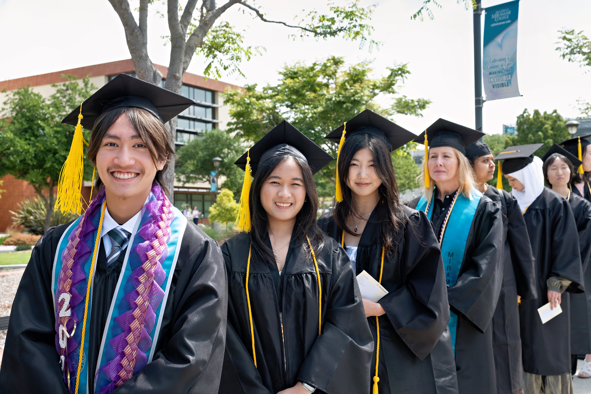 
Seven graduates line up to walk into commencement
