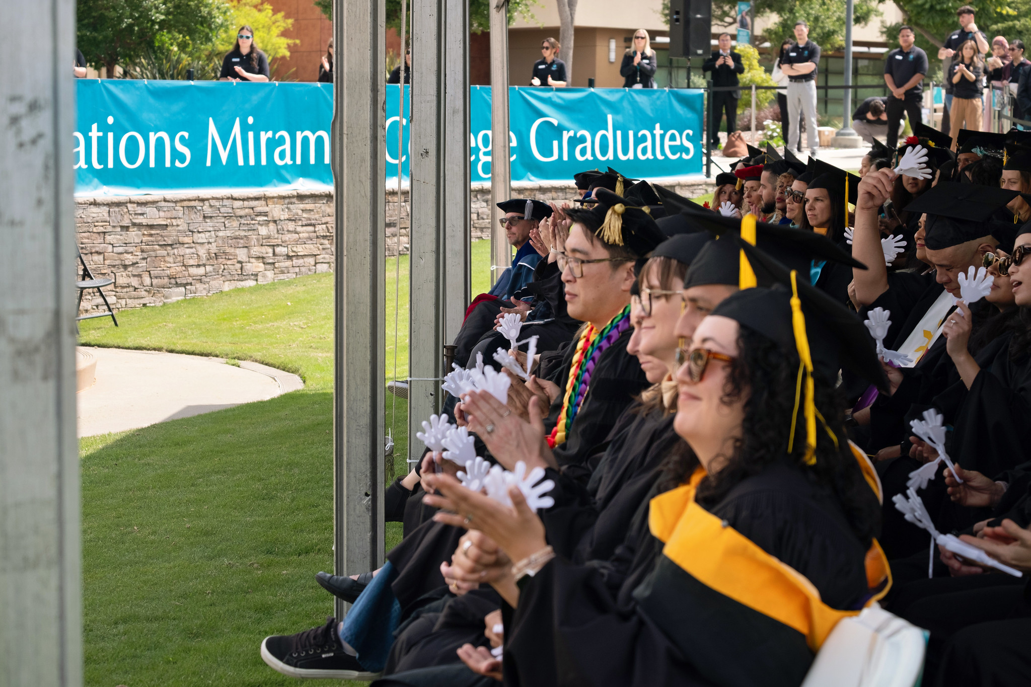 
A group of graduates seated in the front row.
