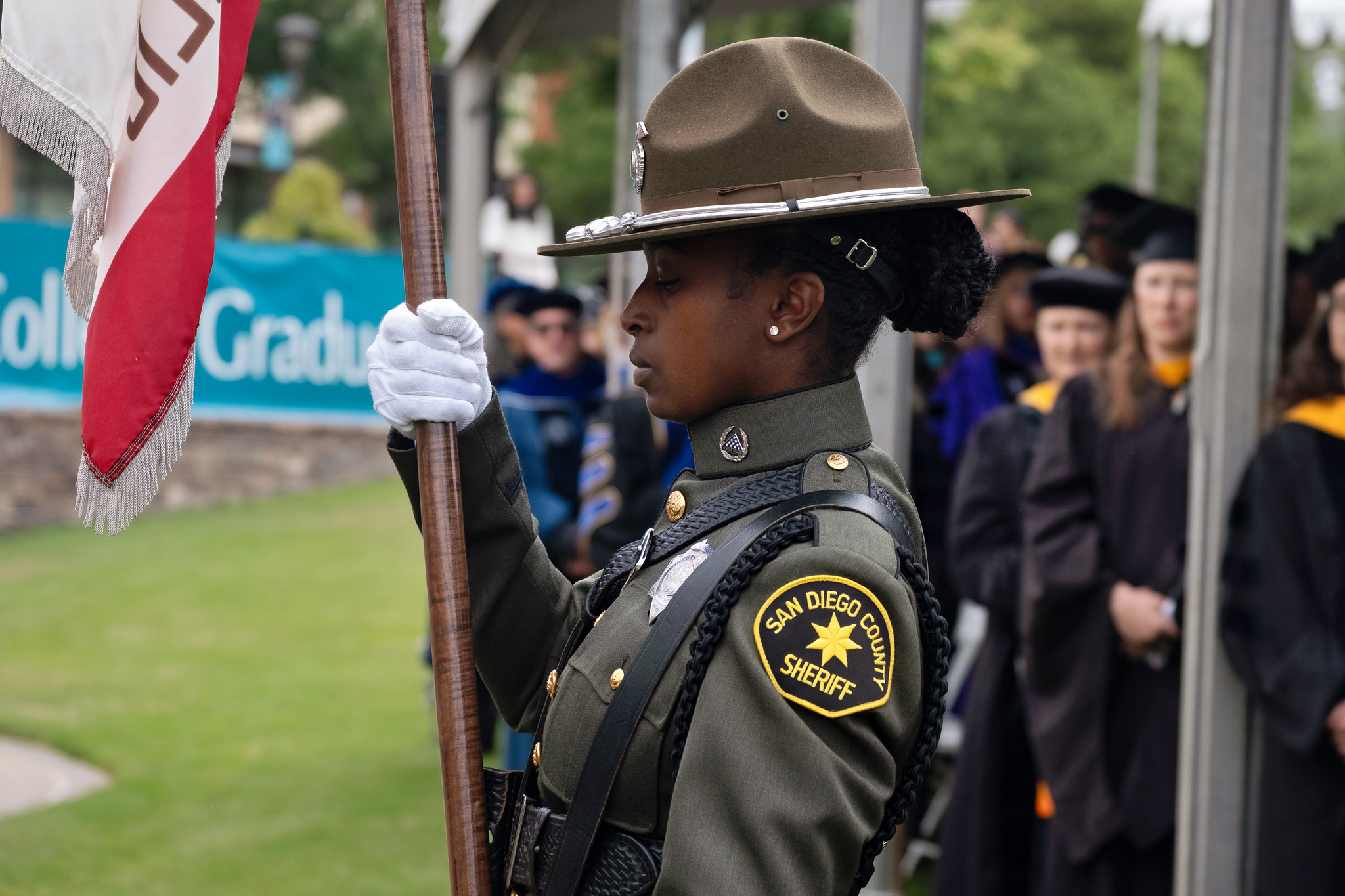 
A member of the sheriff's department holds a flag.
