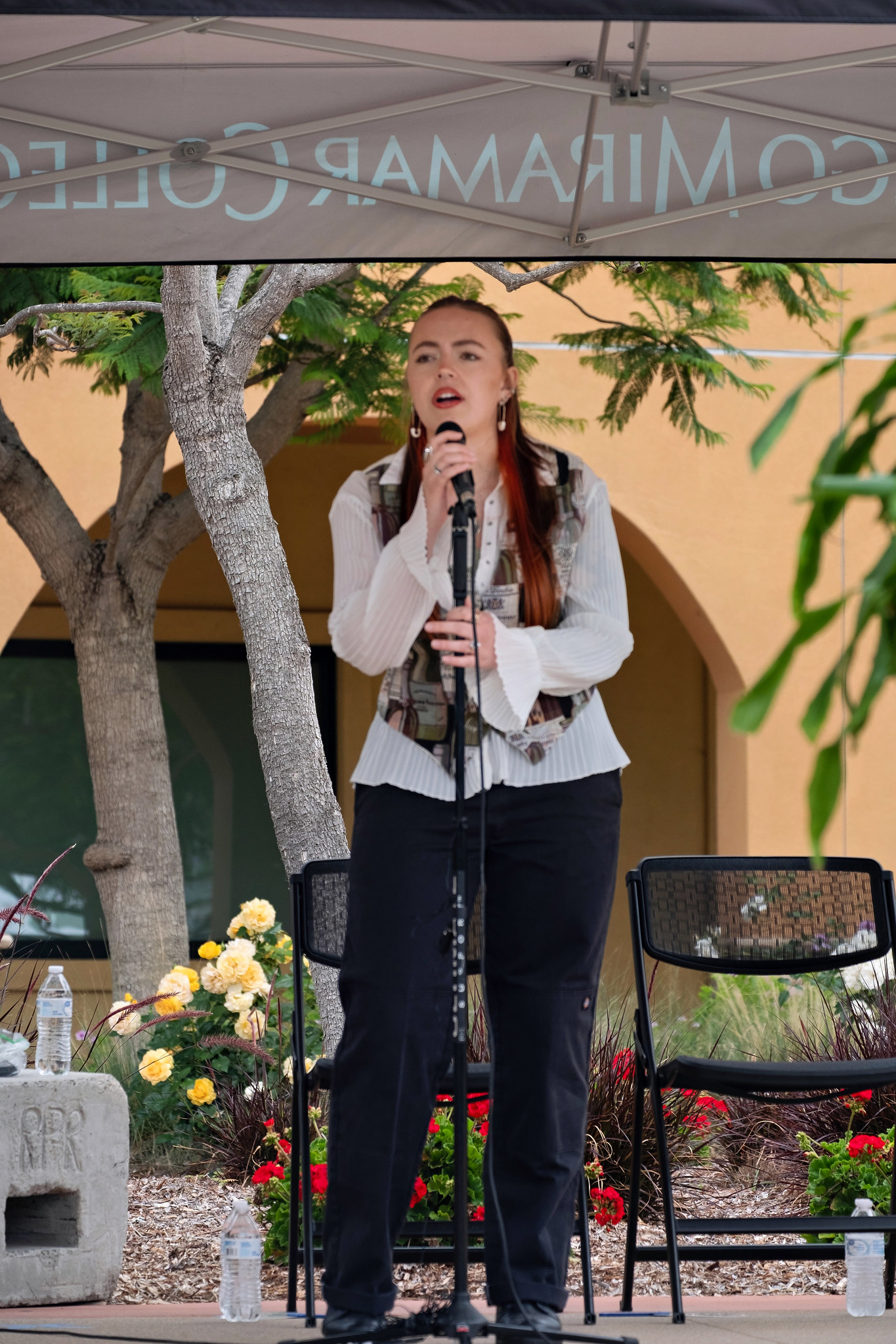 
A woman singing the national anthem on stage.
