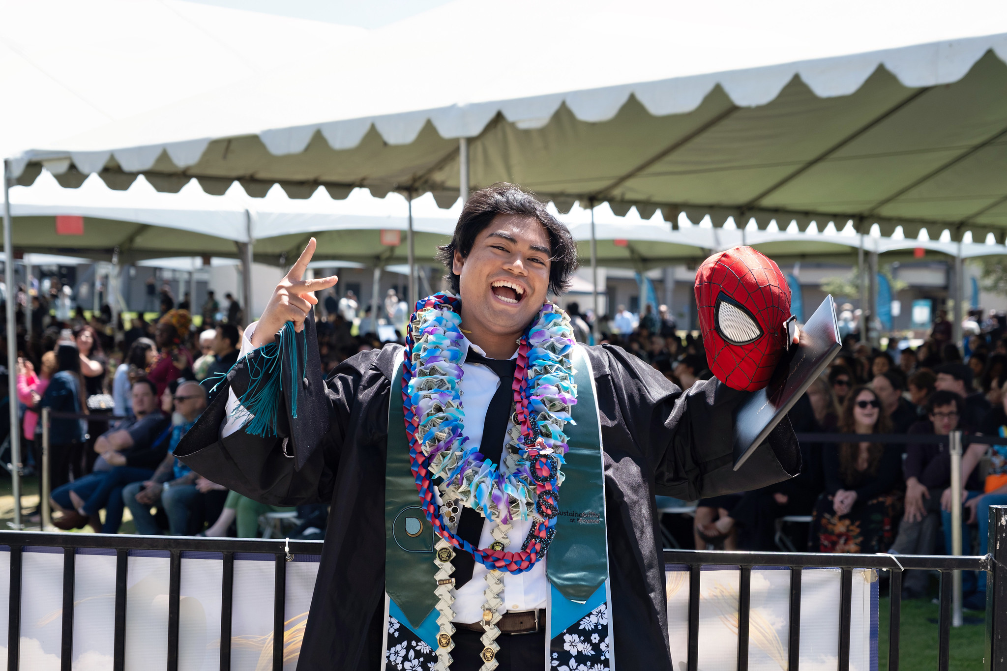
A graduate holds up his degree.
