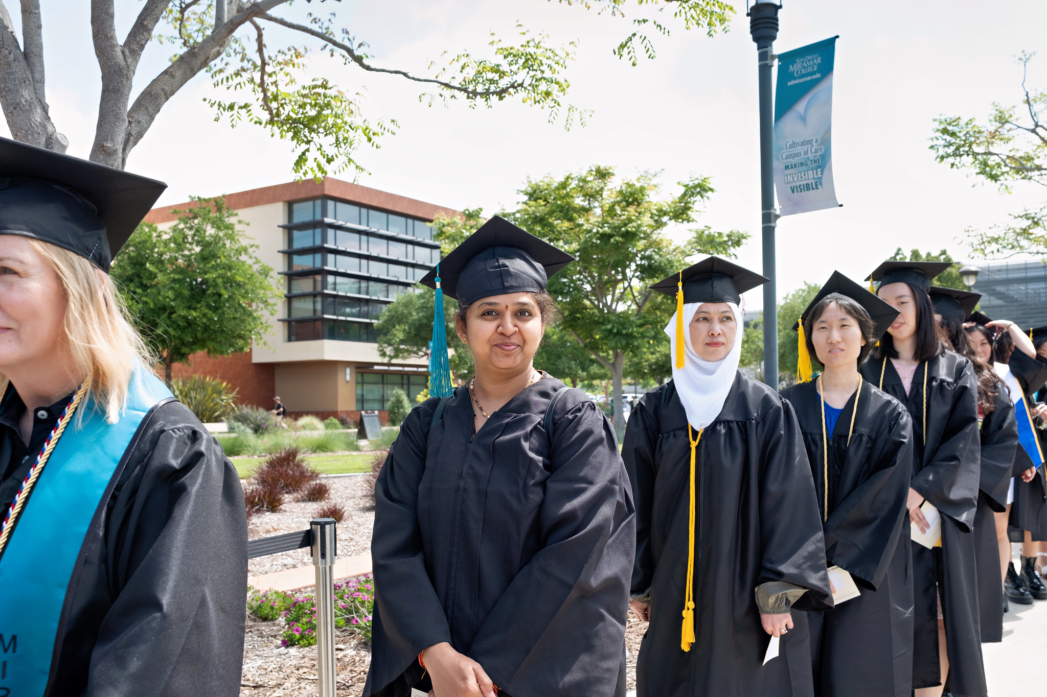 
Eight graduates lined up to walk into commencement.
