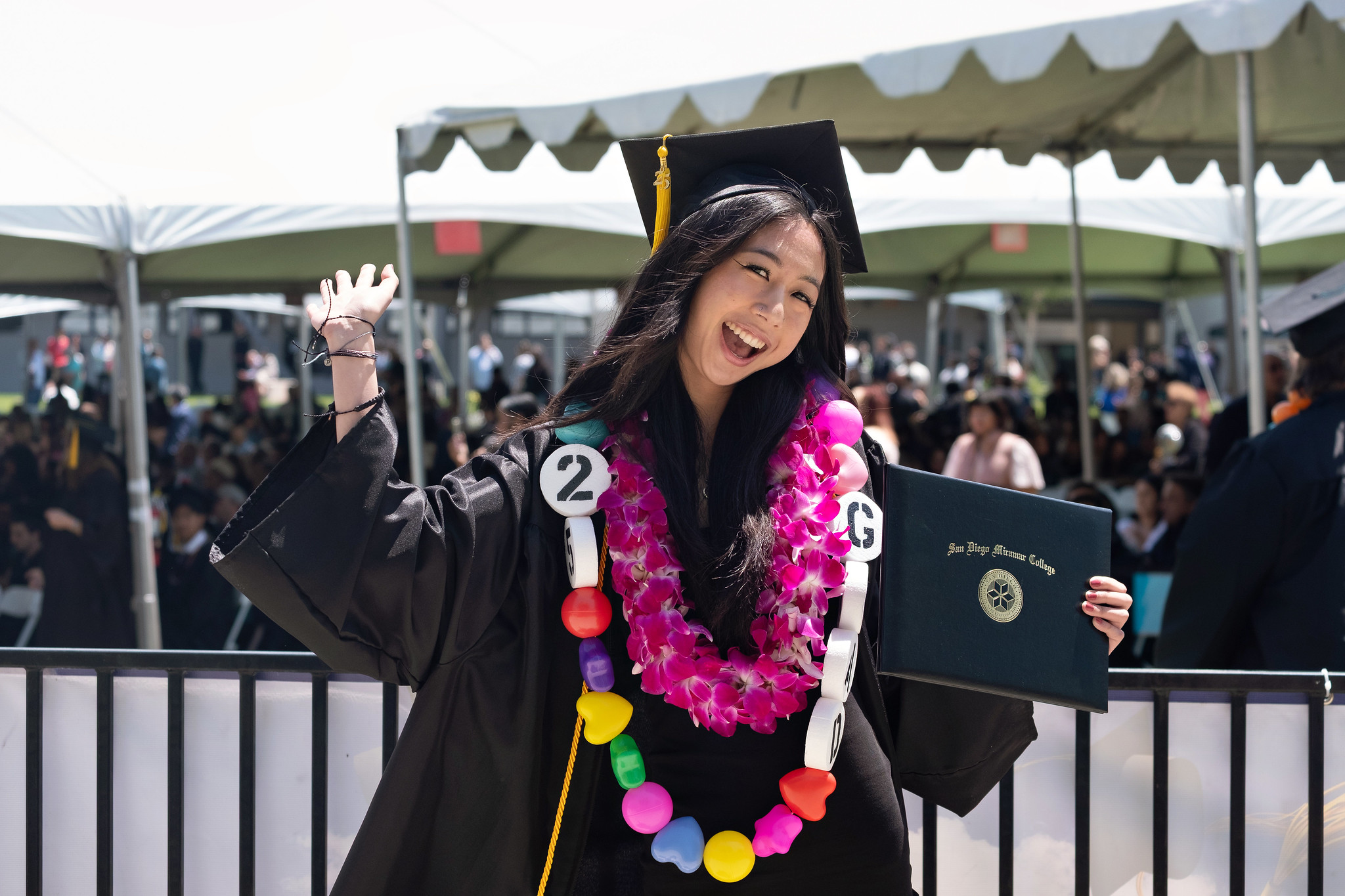 
A graduate holds up her degree.
