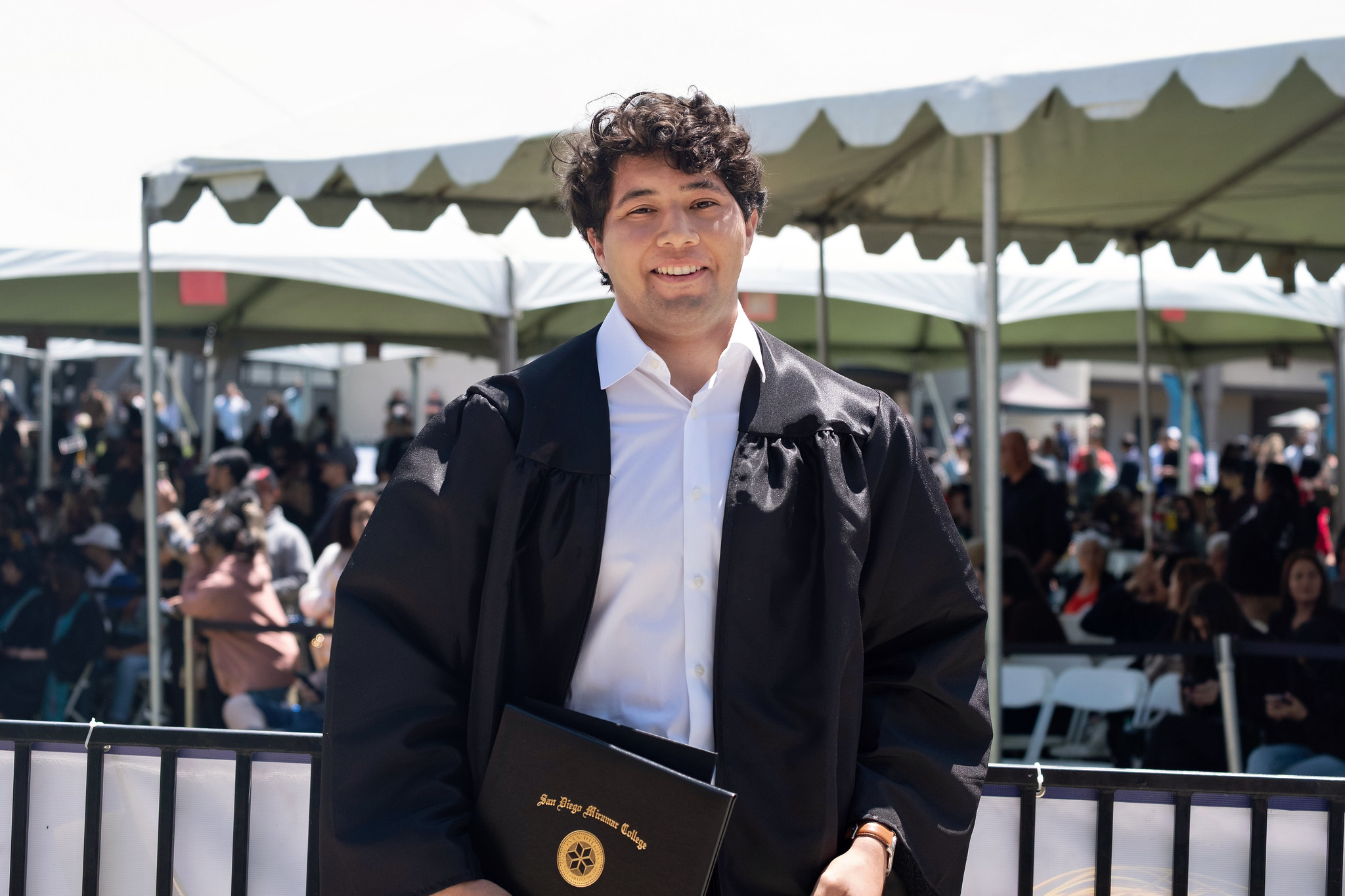 
A graduate holds up his degree.
