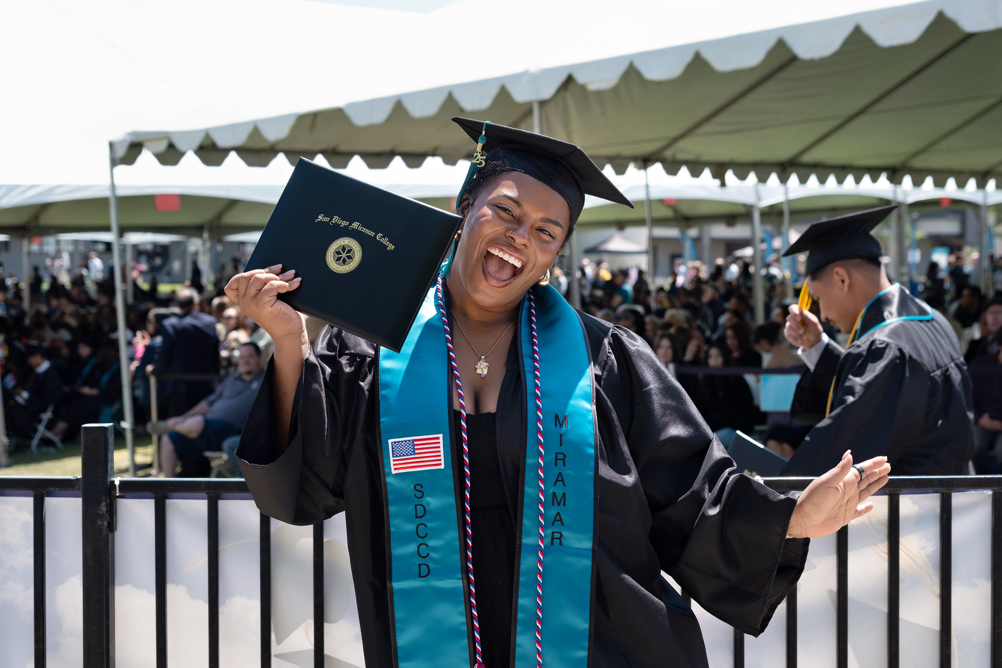 
A graduate holds up her degree.
