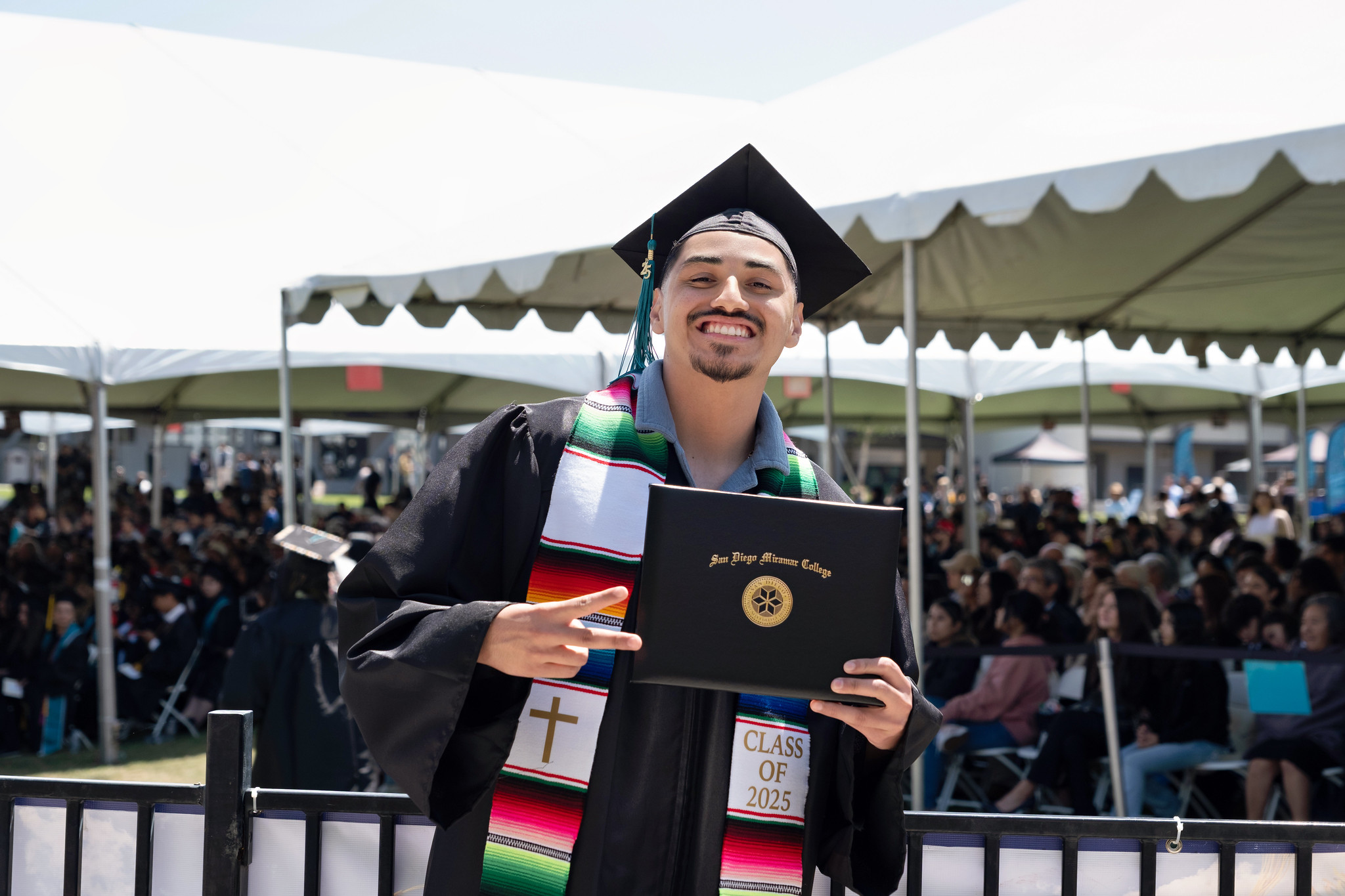 
A graduate holds up his degree.
