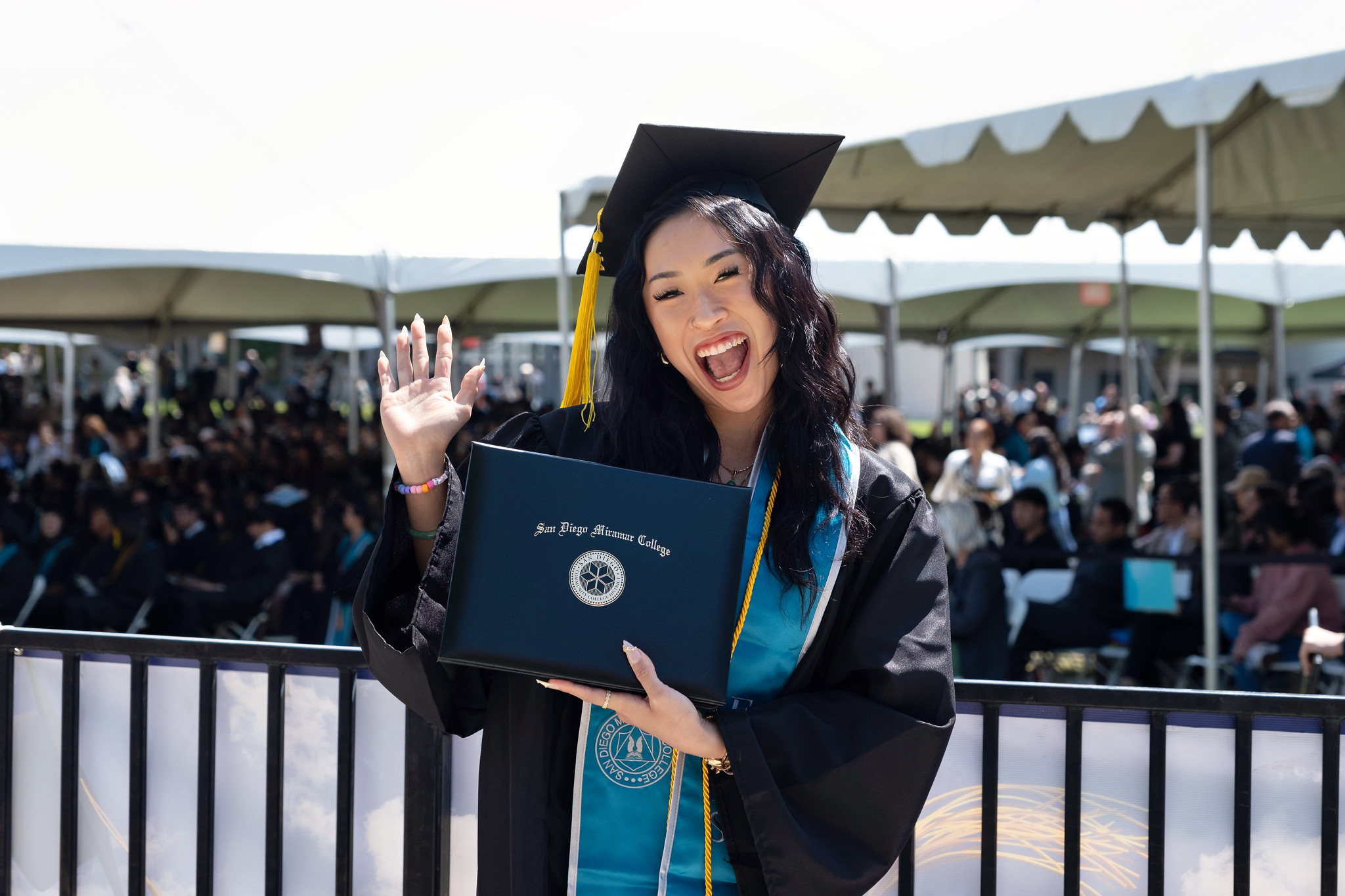 
A graduate holds up her degree.
