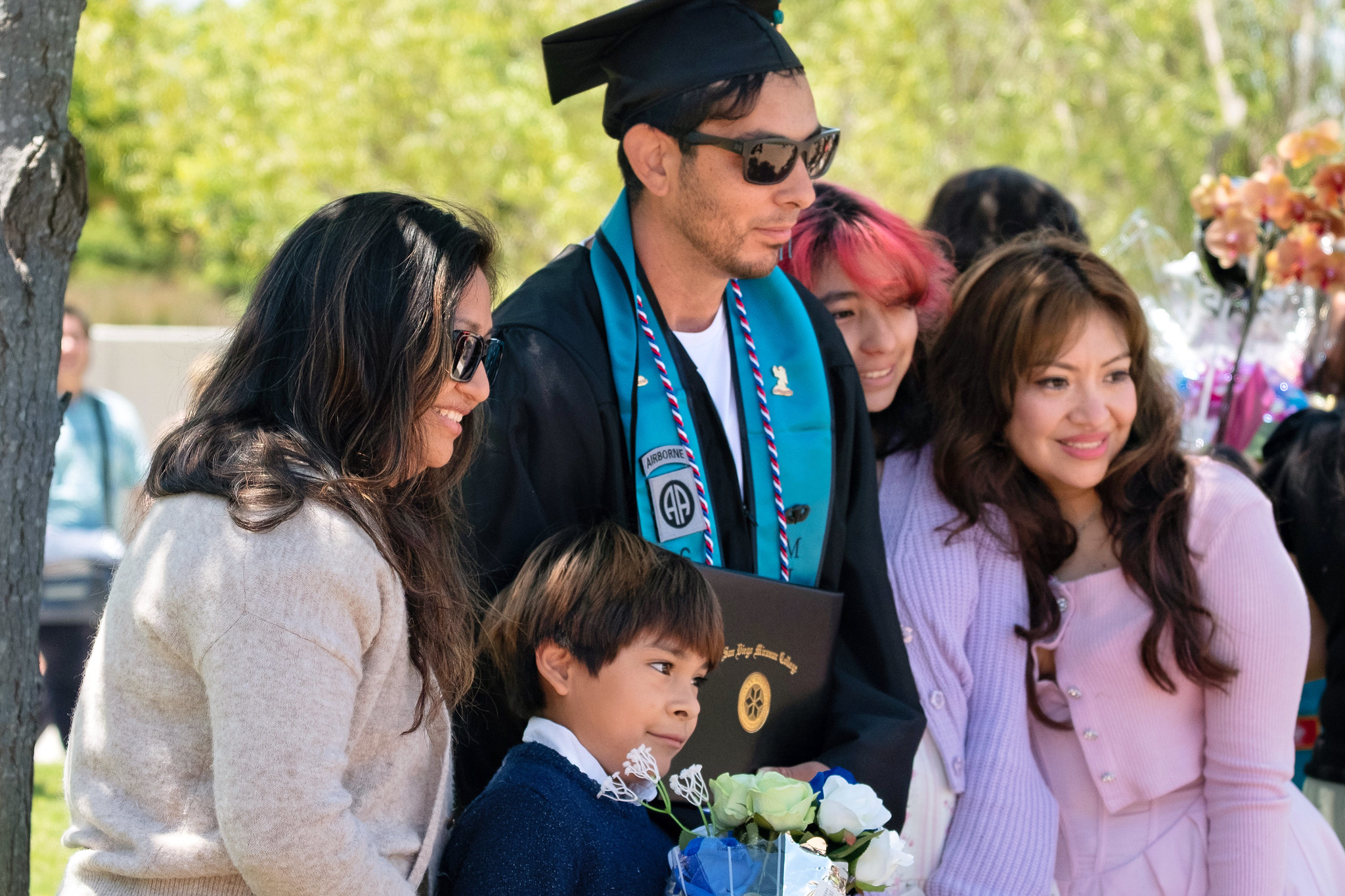 
A graduate takes a photo with four family members.

