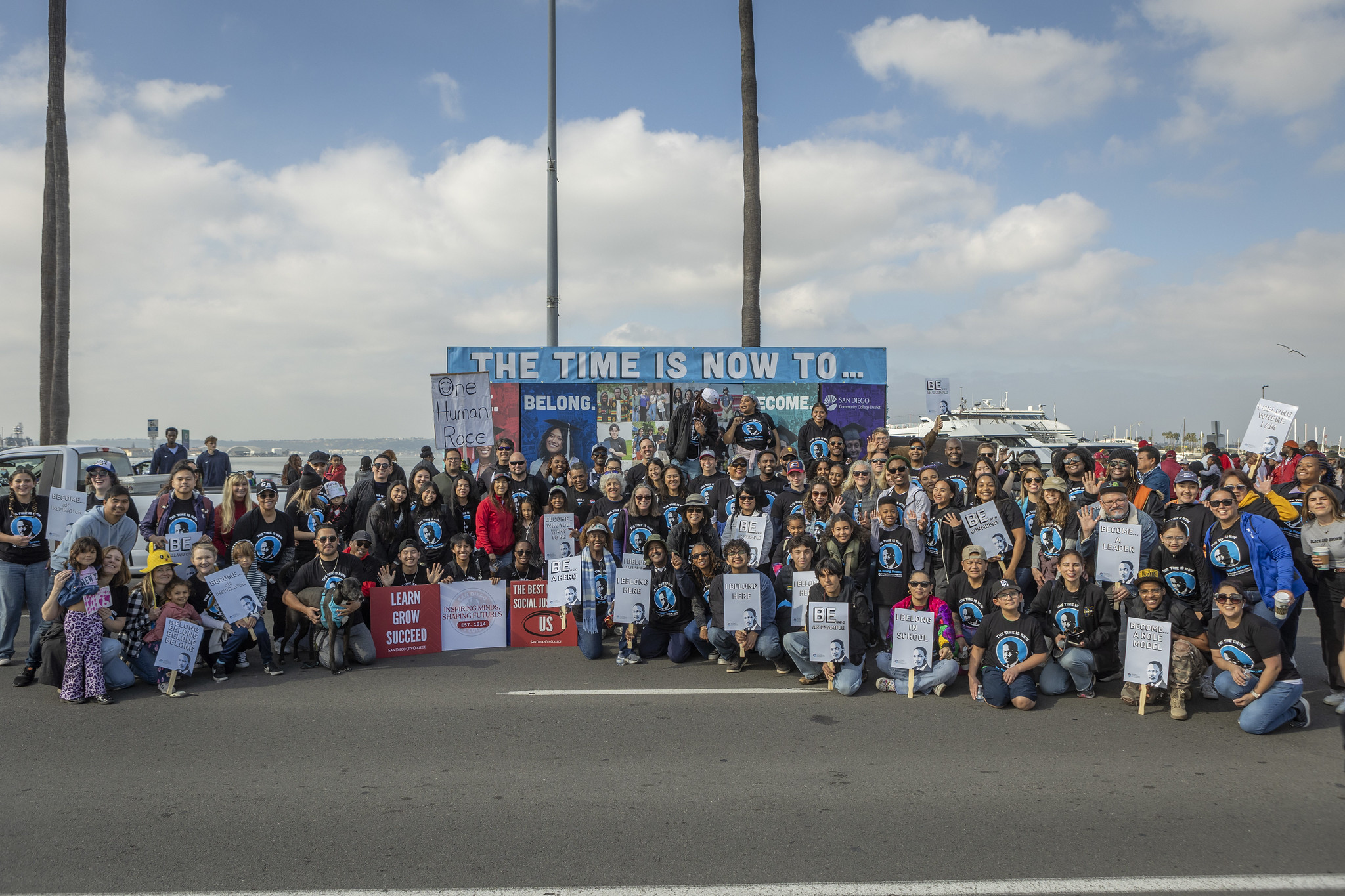 Employees and students with their families gather for a large group photo at the MLK parade.