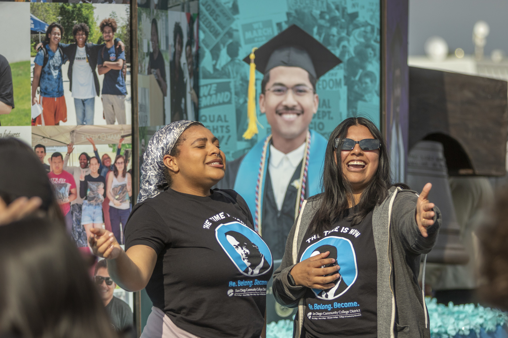 Student trustees Zora Williams and Dahlia Ramirez sing along with the music.