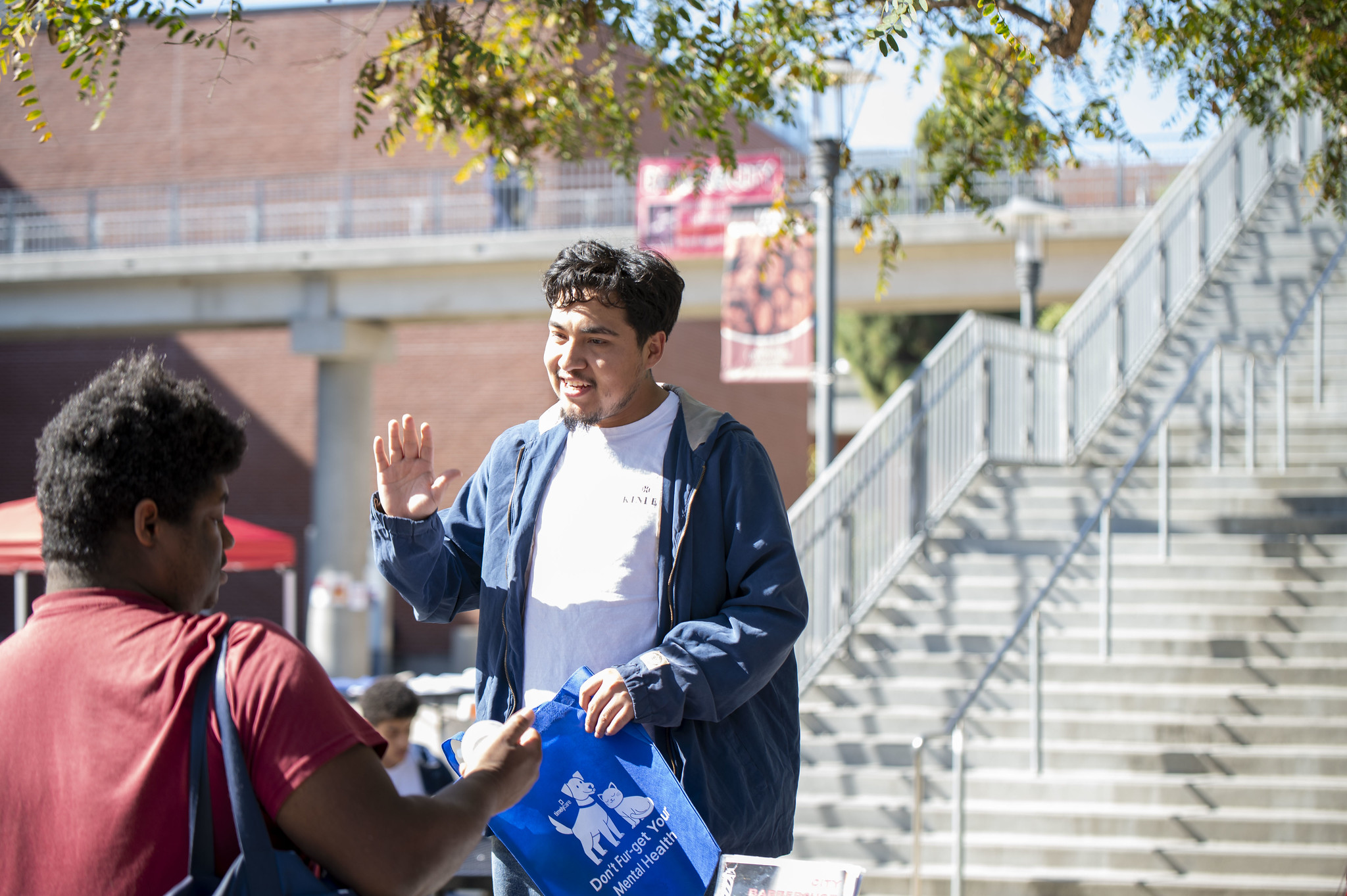 
Two students near stairs at City College.
