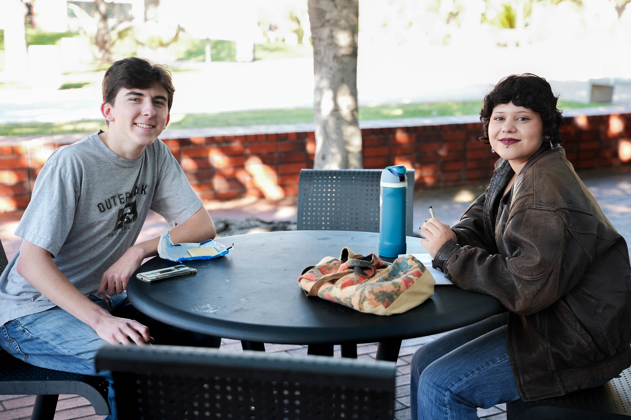 
Two City students sit at an outdoor table.
