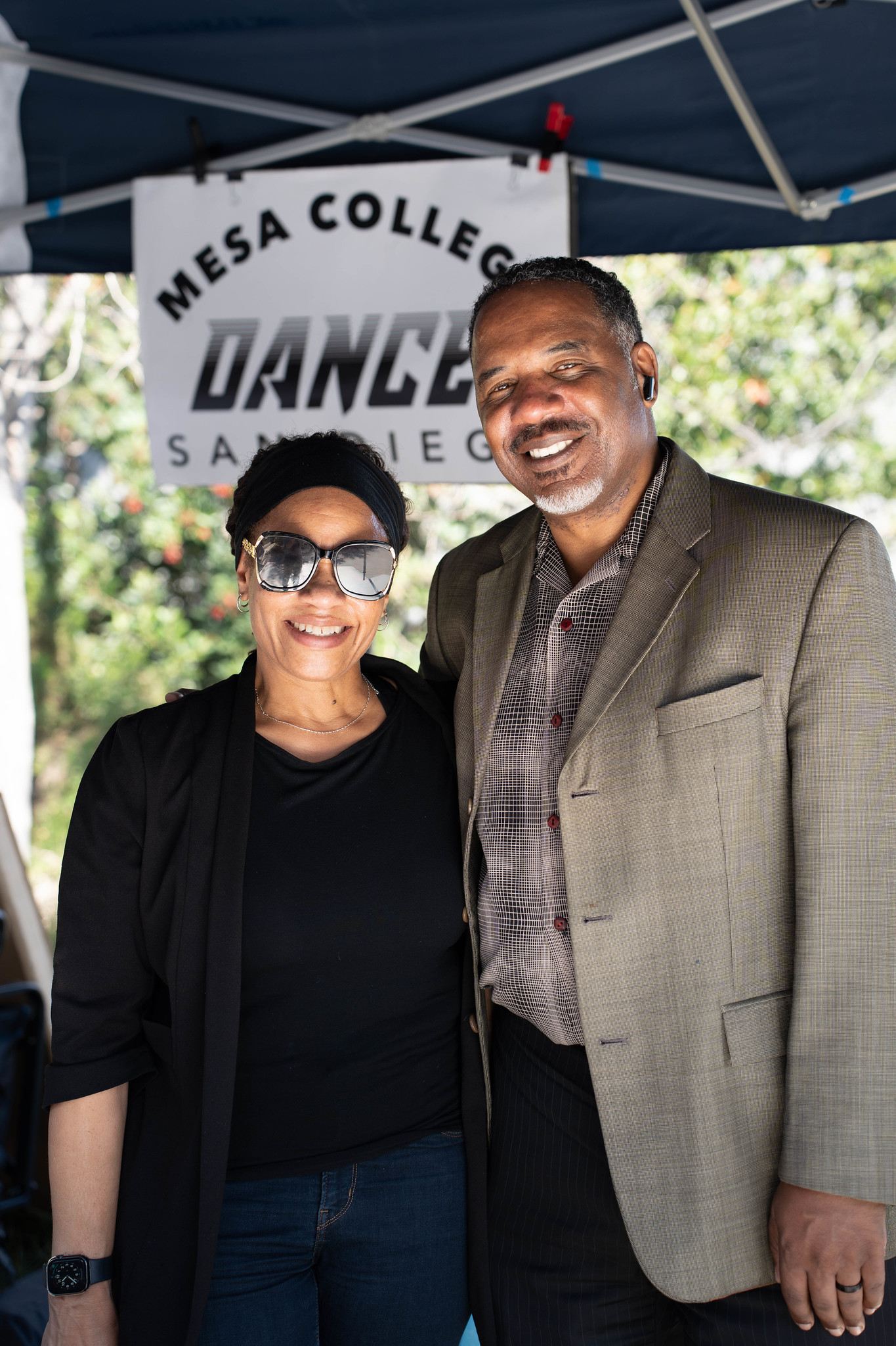 
Two employees at the Mesa College Dance welcome tent.
