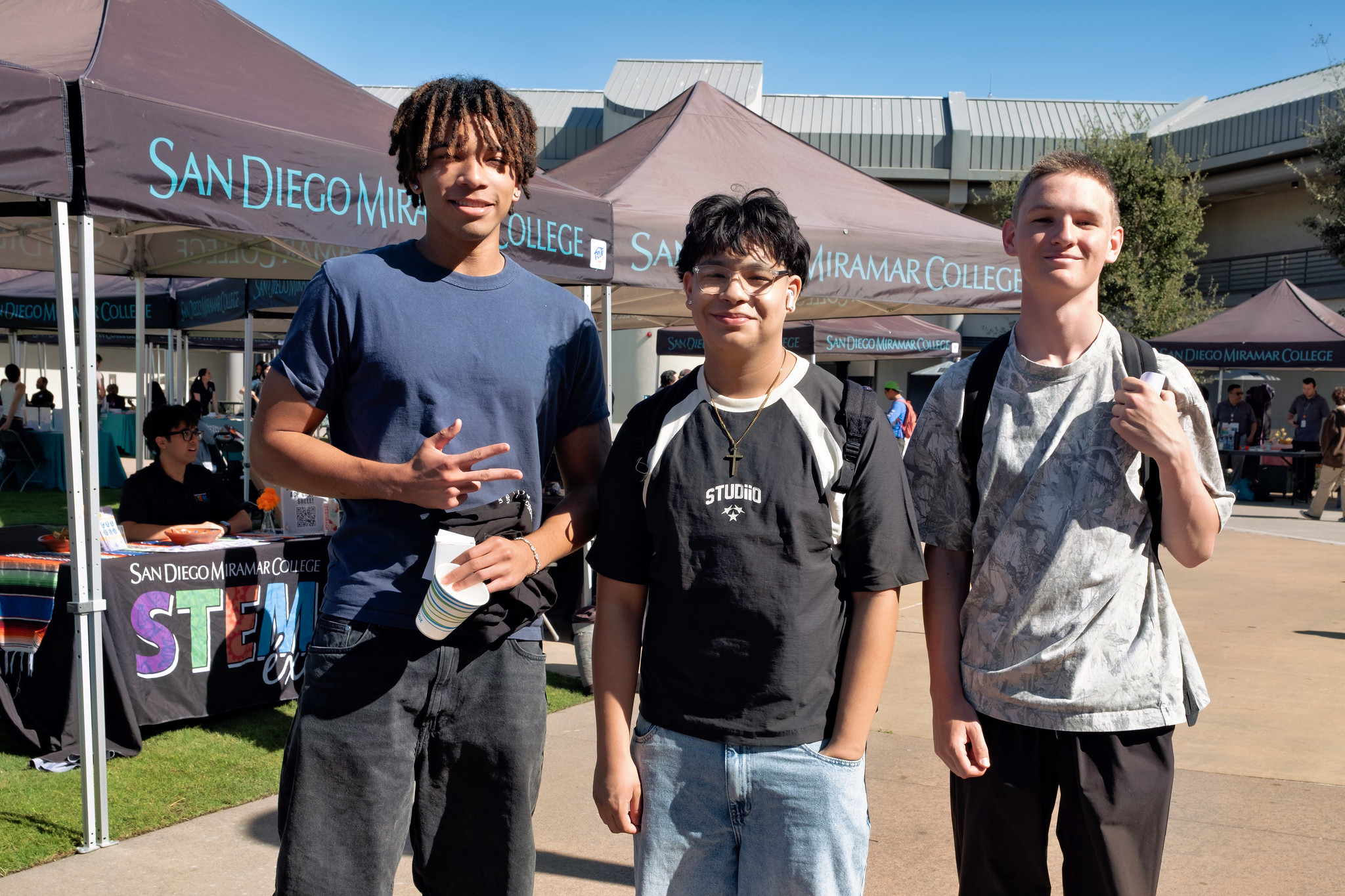 
Three Miramar students near welcome tents.

