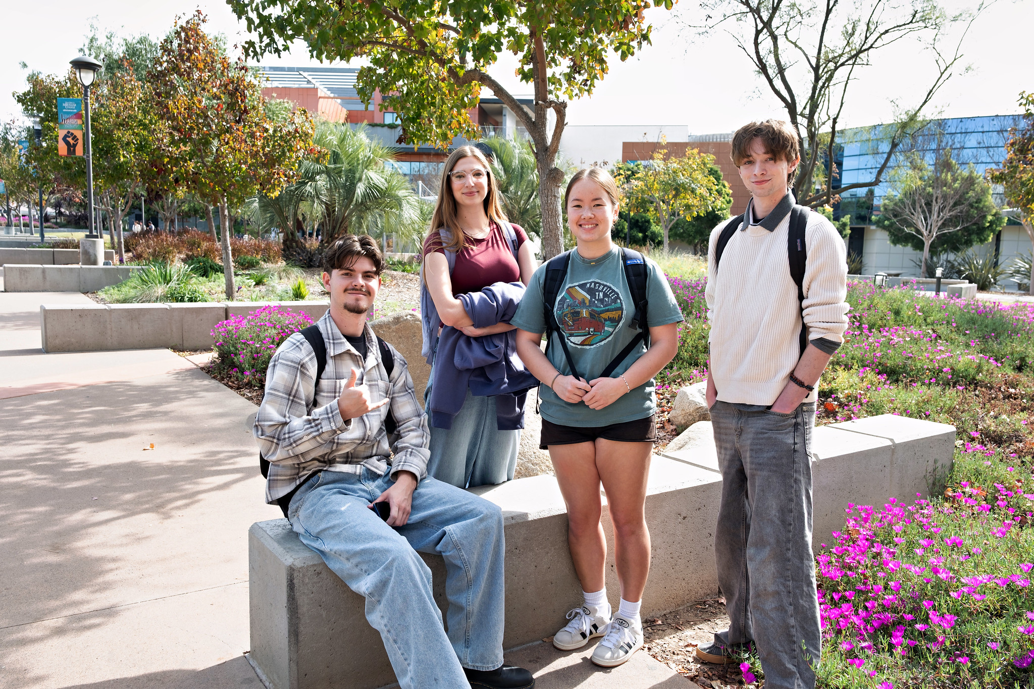 
Four students on the Miramar campus surrounded by greenery and flowers.
